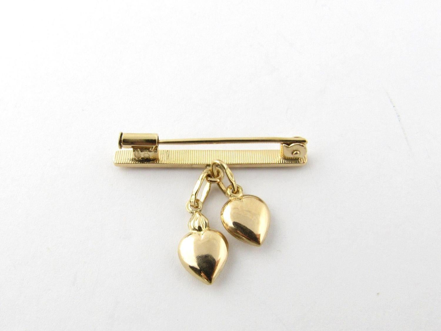 Vintage 18K Yellow Gold Bar Pin with Dangling Hearts 

This beautiful pin is the perfect gift for that special someone. 

Measures approx 29 mm x 4 mm x 19 mm. 

3.3 g / 2.1 dwt. 

Hallmarked 750 1 A UNO-AR. 

Pin is in very good pre-owned condition
