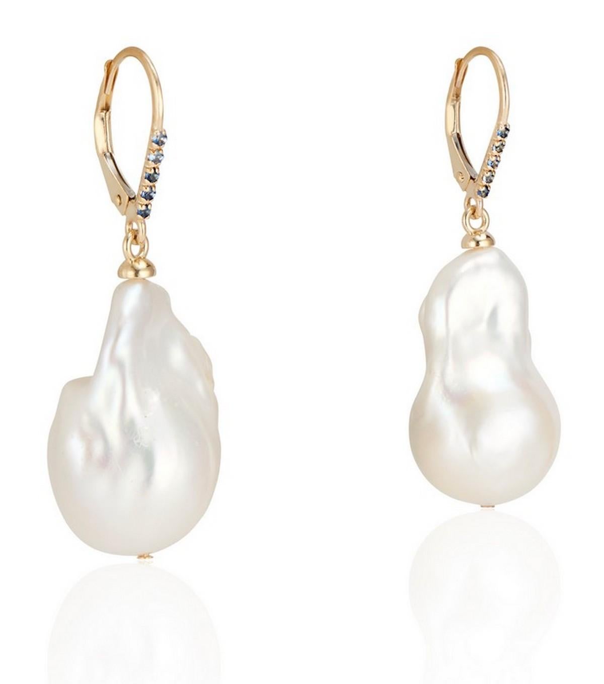 

Infuse your ensemble with a whisper of sophistication with these alluring Baroque Pearl Earrings. Each piece is a symphony of elegance, featuring a 14-17mm gleaming freshwater baroque pearl that delicately hangs from a lever back adorned with