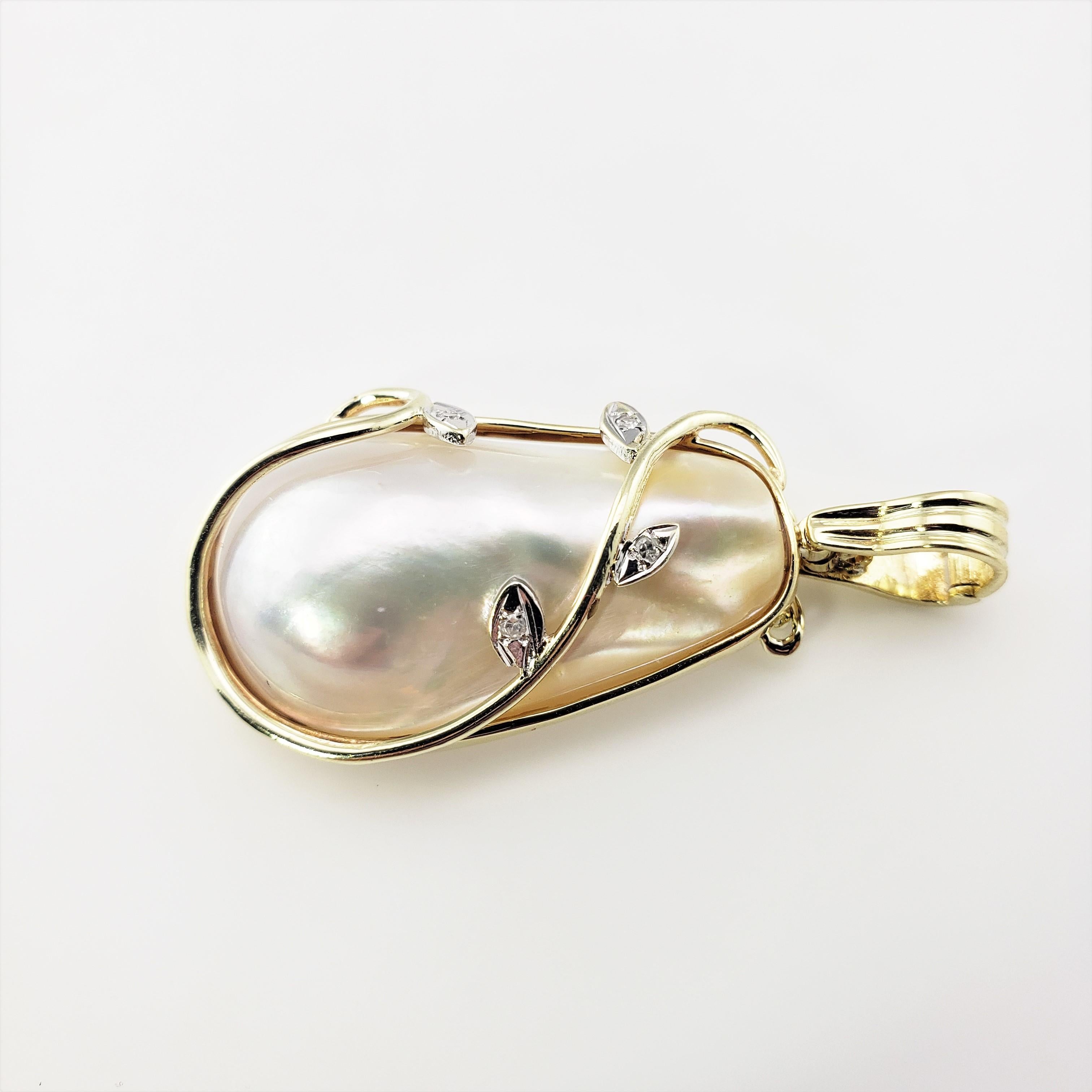 14 Karat Yellow Gold Baroque Pearl and Diamond Pendant-

This lovely pendant features one baroque pearl accented with four round single cut diamonds set in classic 14K yellow gold.

*Chain not included.

Approximate total diamond weight:  .02