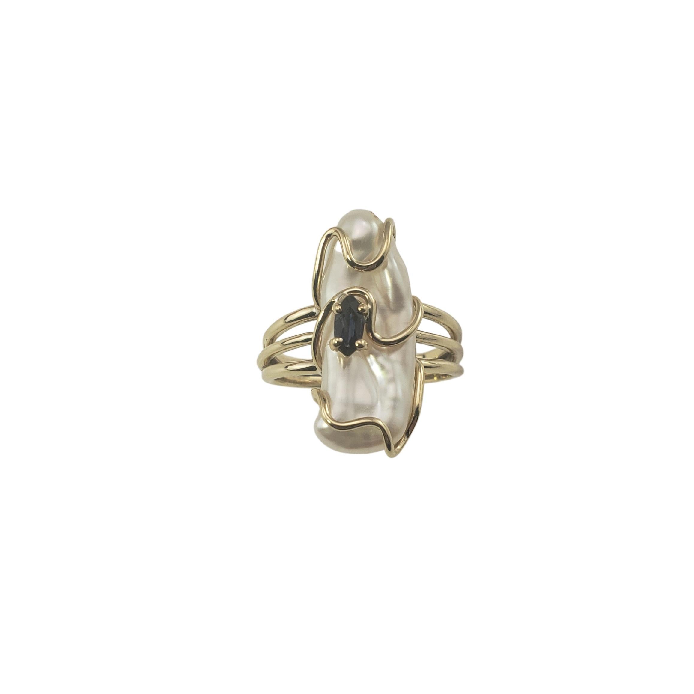 This lovely ring features one cultured baroque pearl (22 mm x 10 mm) and one marquis natural sapphire (5 mm x 3 mm) set in classic 14K yellow gold.

Natural sapphire is approx. 0.15cts. Medium slightly greenish blue 

Shank:  2 mm.

Size: