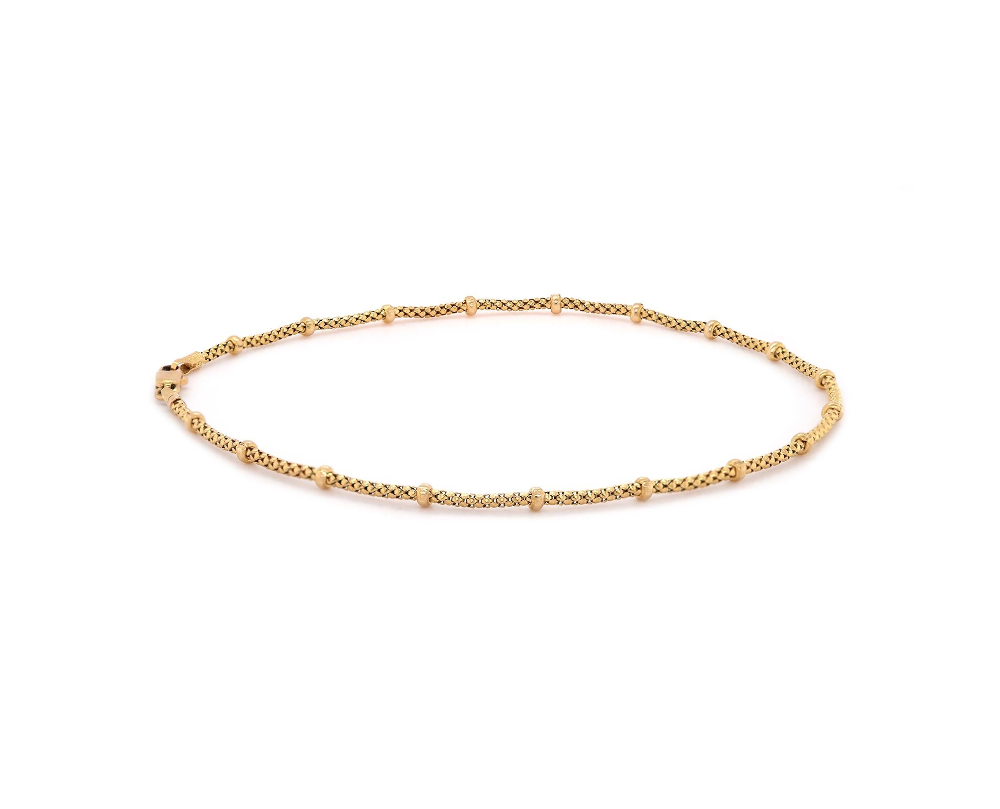 Designer: custom
Material: 14K yellow gold 
Dimensions: bracelet will fit up to a 9.5-inch wrist
Weight: 3.35 grams
