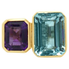 Anello in oro giallo 14 carati con castone incastonato di topazio blu e ametista