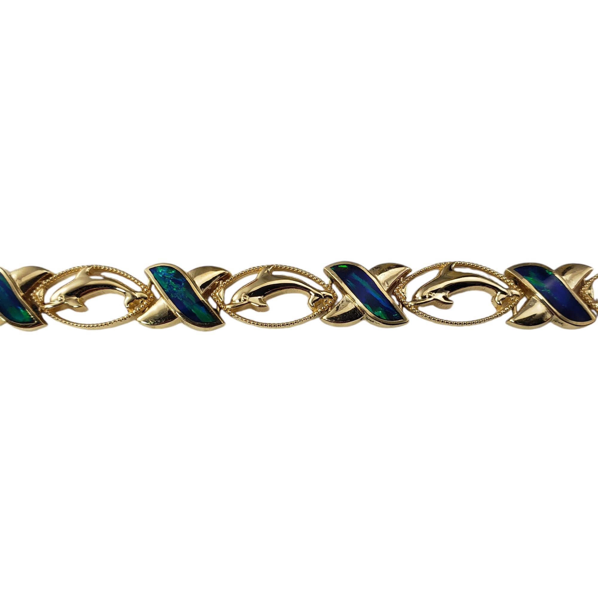 14 Karat Yellow Gold and Black Opal XO Dolphin Bracelet-

This elegant XO style dolphin bracelet features eight tablet cut black opal gemstones (9.5 mm x 3.2 mm) set in beautifully detailed 14K yellow gold. Width: 8 mm.

Stamped: 14K

Size: 7.25