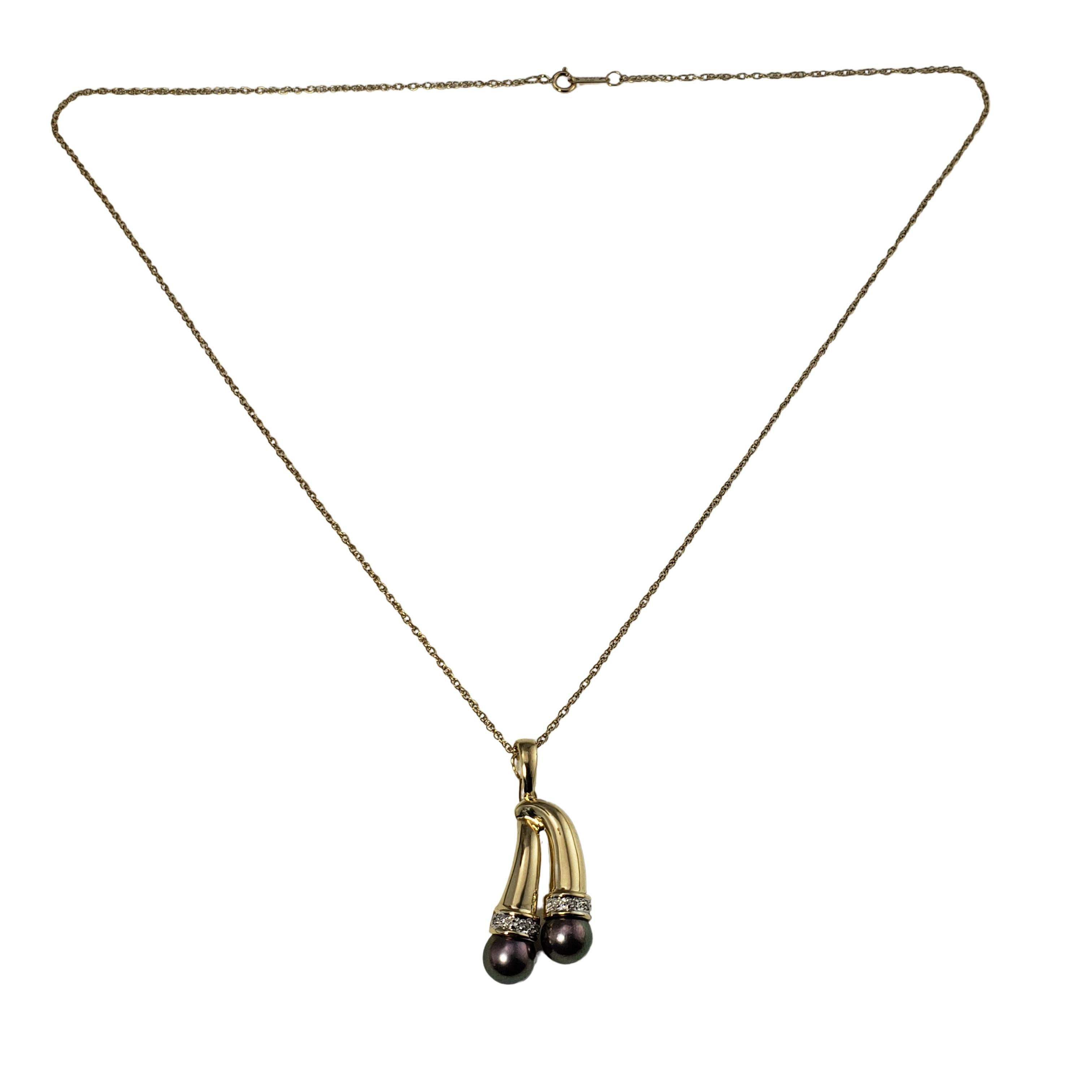 Vintage 14 Karat Yellow Gold Black Pearl and Diamond Pendant Necklace-

This lovely pendant features two black pearls (7 mm each) and eight round single cut diamonds set in 14K yellow gold. Suspends from a classic cable chain.

Approximate total