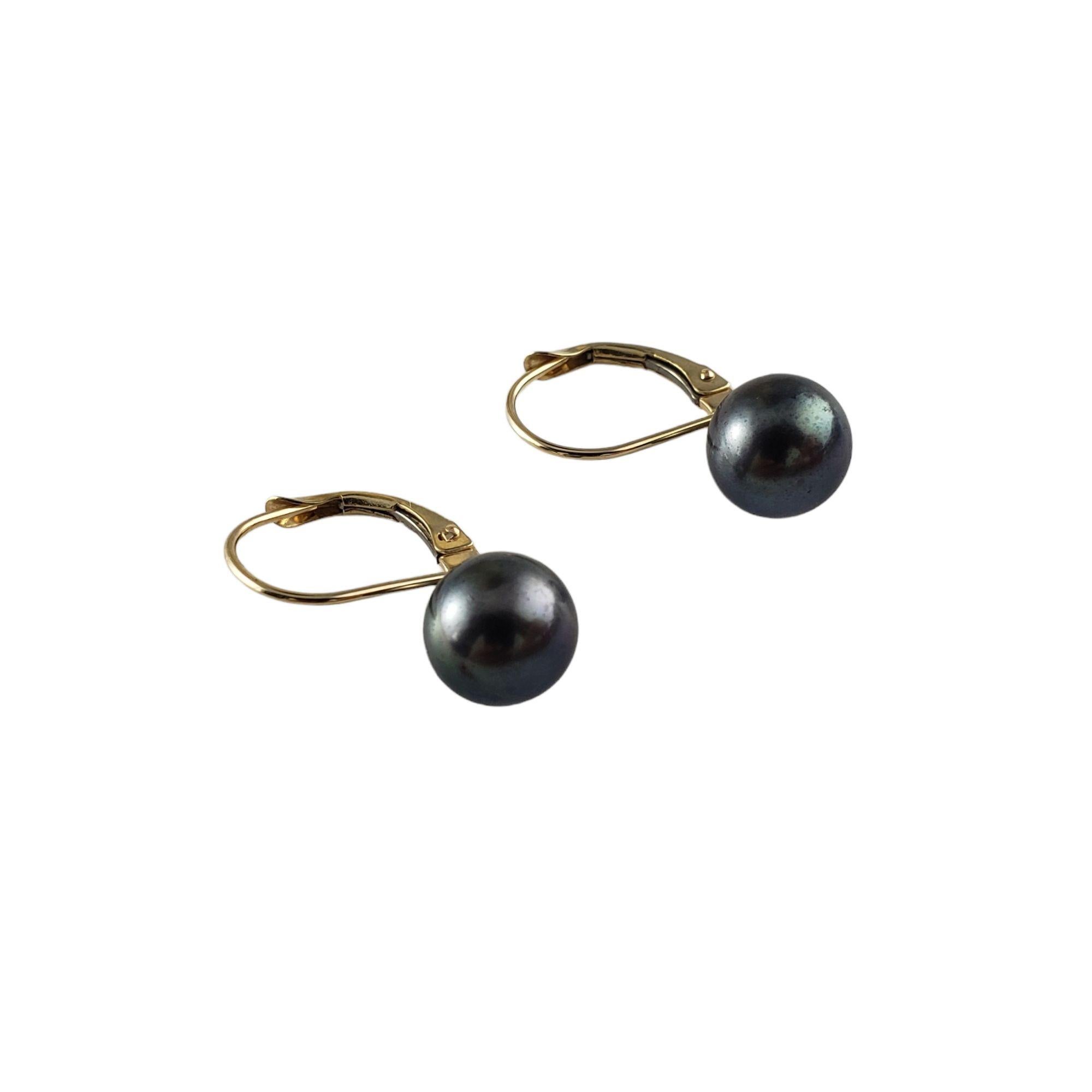 These elegant earrings each feature one black pearl (8 mm) set in classic 14K yellow gold.  Hinged kidney wire closures.

Size: 17 mm x 8 mm

Weight:  1.1 dwt. /  1.8 gr.

Stamped: 14KT

Very good condition, professionally polished.

Will come