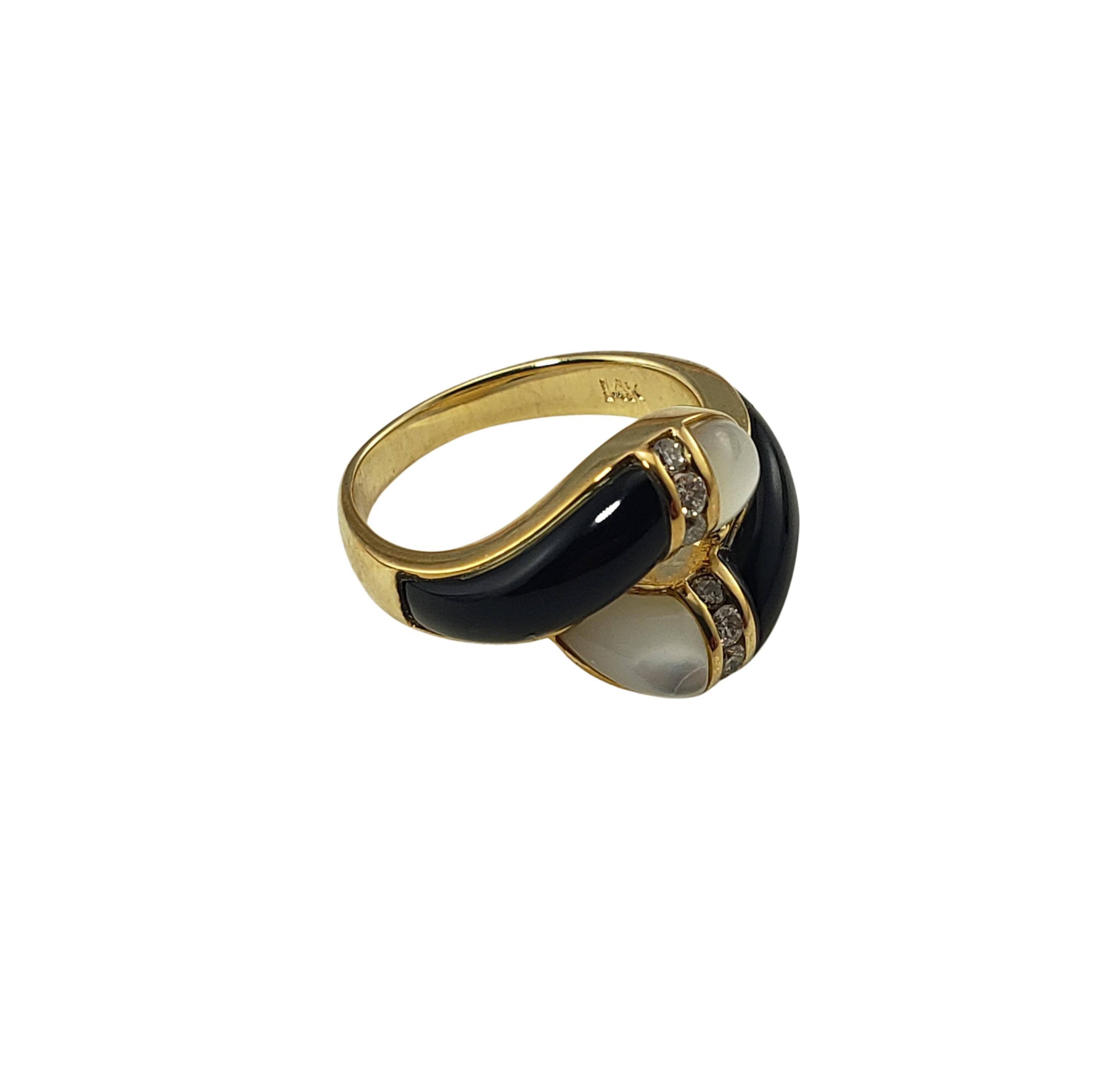 Vintage 14 Karat Yellow Gold Black/White Onyx and Diamond Ring Size 6.25-

This lovely black and white onyx ring features eight round brilliant cut diamond set in classic 14K yellow gold. Width: 14 mm.
Shank: 3 mm.

Approximate total diamond weight: