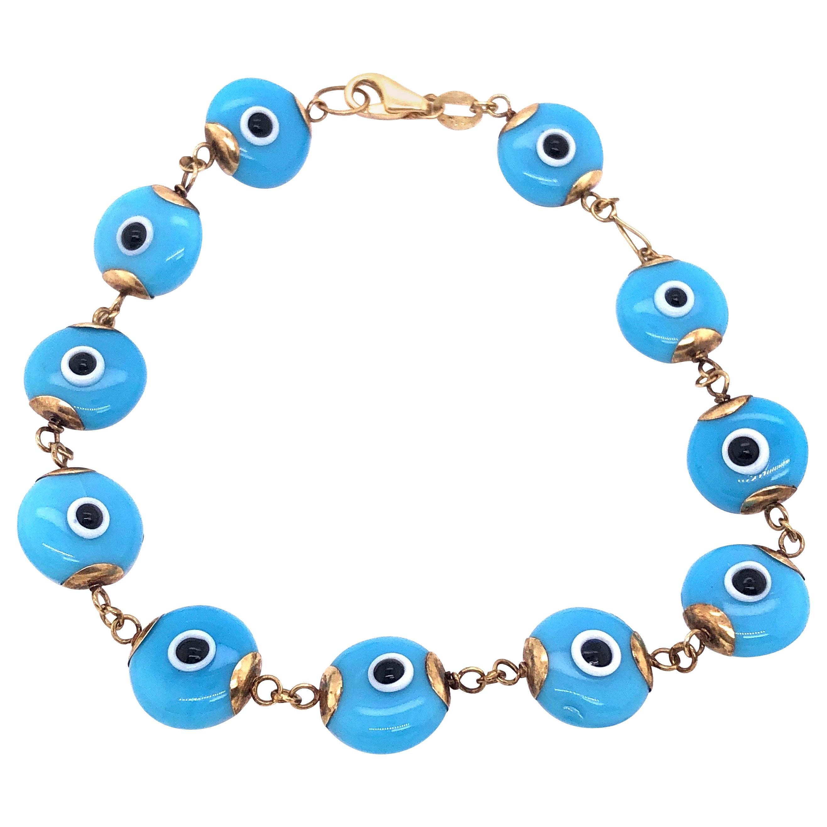 14 Karat Yellow Gold Blue Ceramic Evil Eye Charm Bracelet For Sale