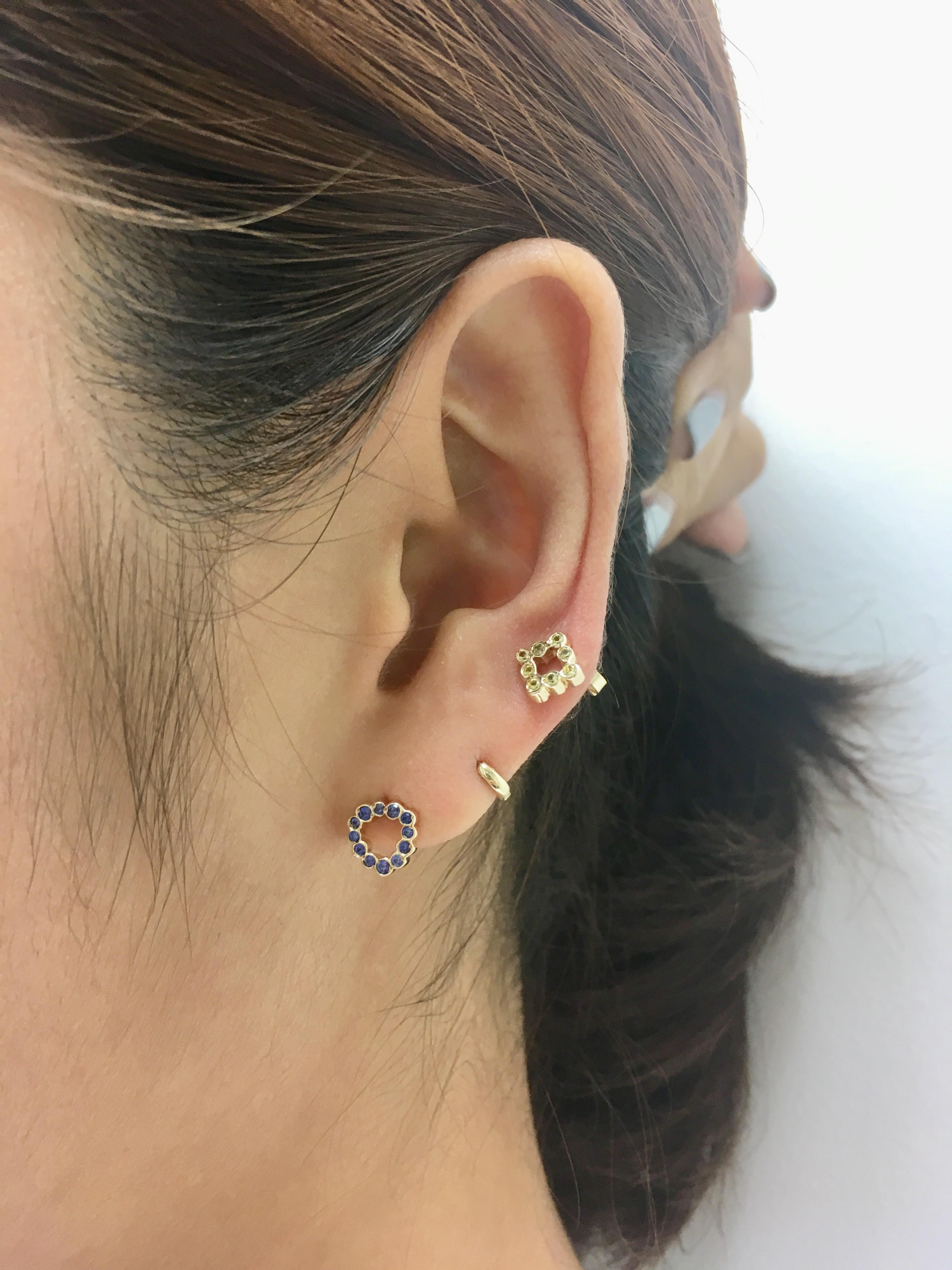 Wear these miniature triangle shaped stud earings with Blue Sapphires for a punch of
color on your ears. Mix and match with your favorite single earrings or wear them as a pair.

Inspired by seeing the cross-section view of life, as if slicing a