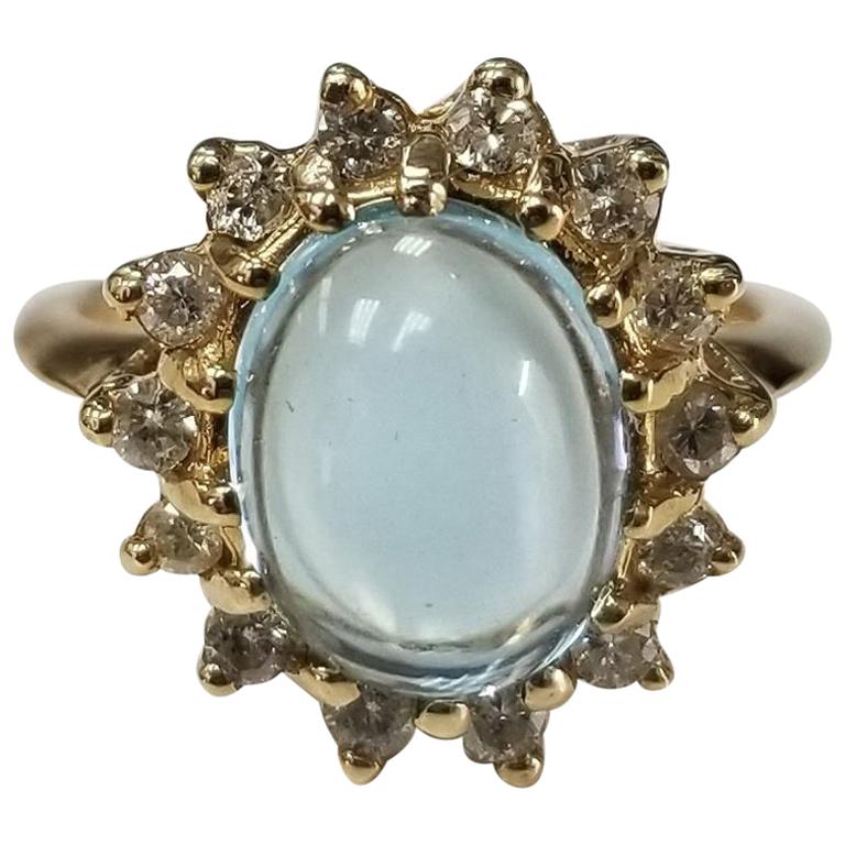 14 Karat Yellow Gold Blue Topaz Cabochon and Diamond Ring For Sale