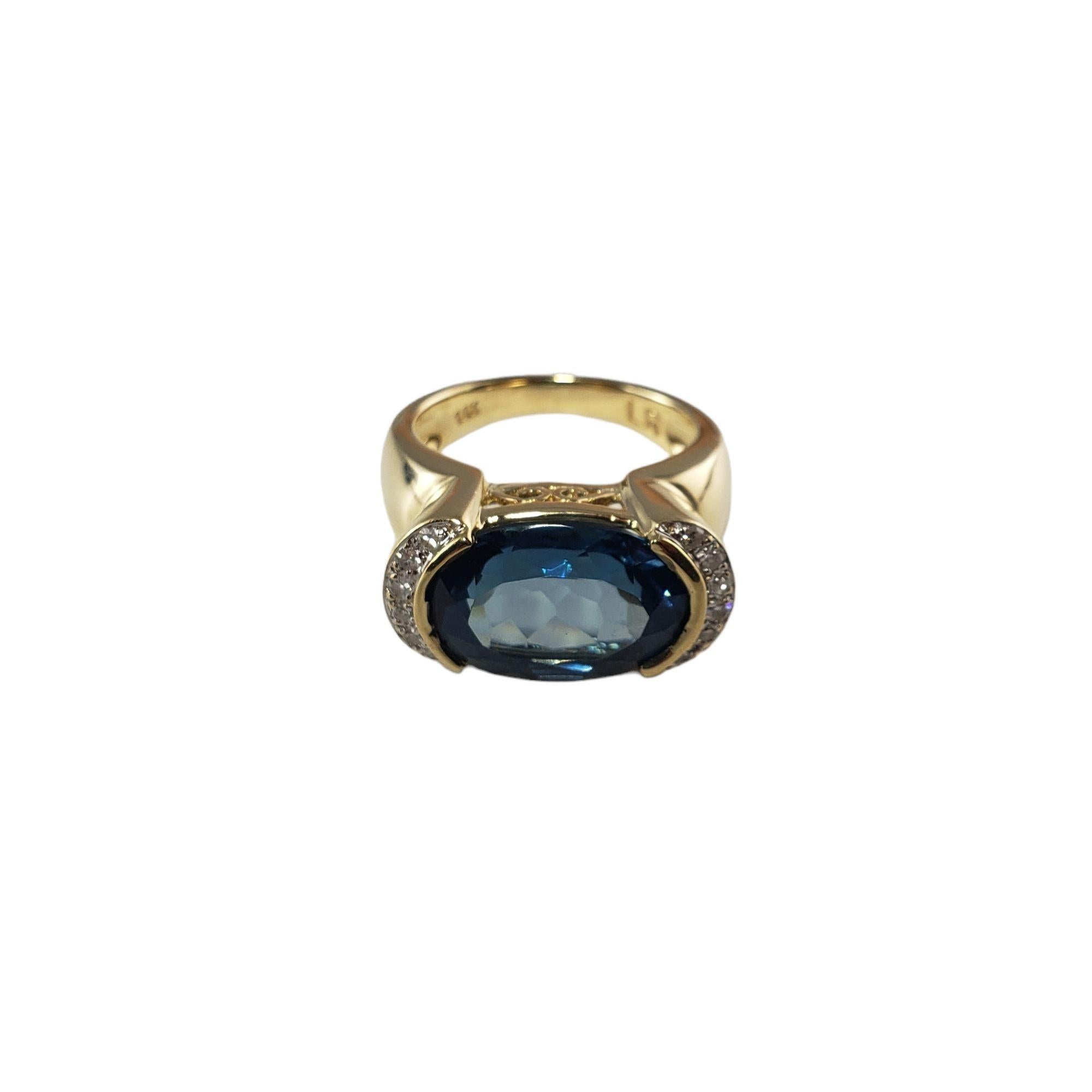 This stunning ring features one east/west set oval blue topaz (14 mm x 10 mm) and 12 round single cut diamonds set in classic 14K yellow gold.

Width:  10 mm.  Shank:  2 mm.

Topaz weight:  7.50 ct.

Total diamond weight:  .13 ct.

Diamond color: