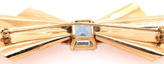 14 Karat Yellow Gold Bow Brooch with Blue Topaz and Diamond Accents