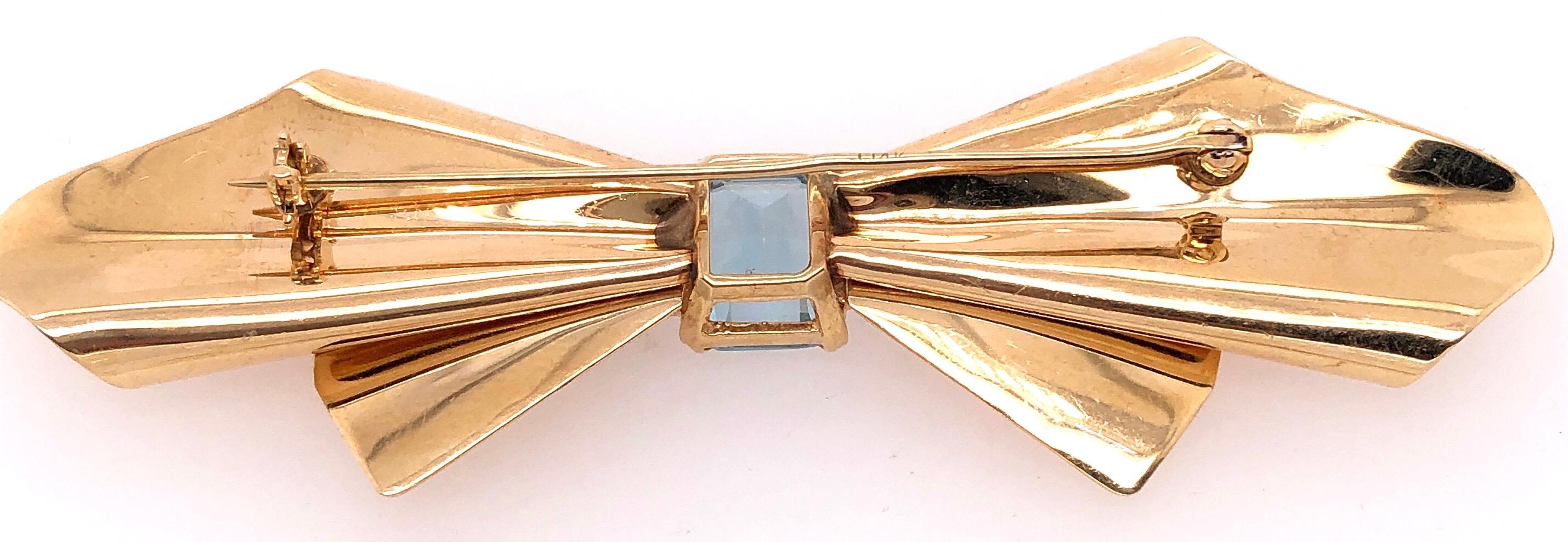 Women's or Men's 14 Karat Yellow Gold Bow Brooch with Blue Topaz and Diamond Accents For Sale