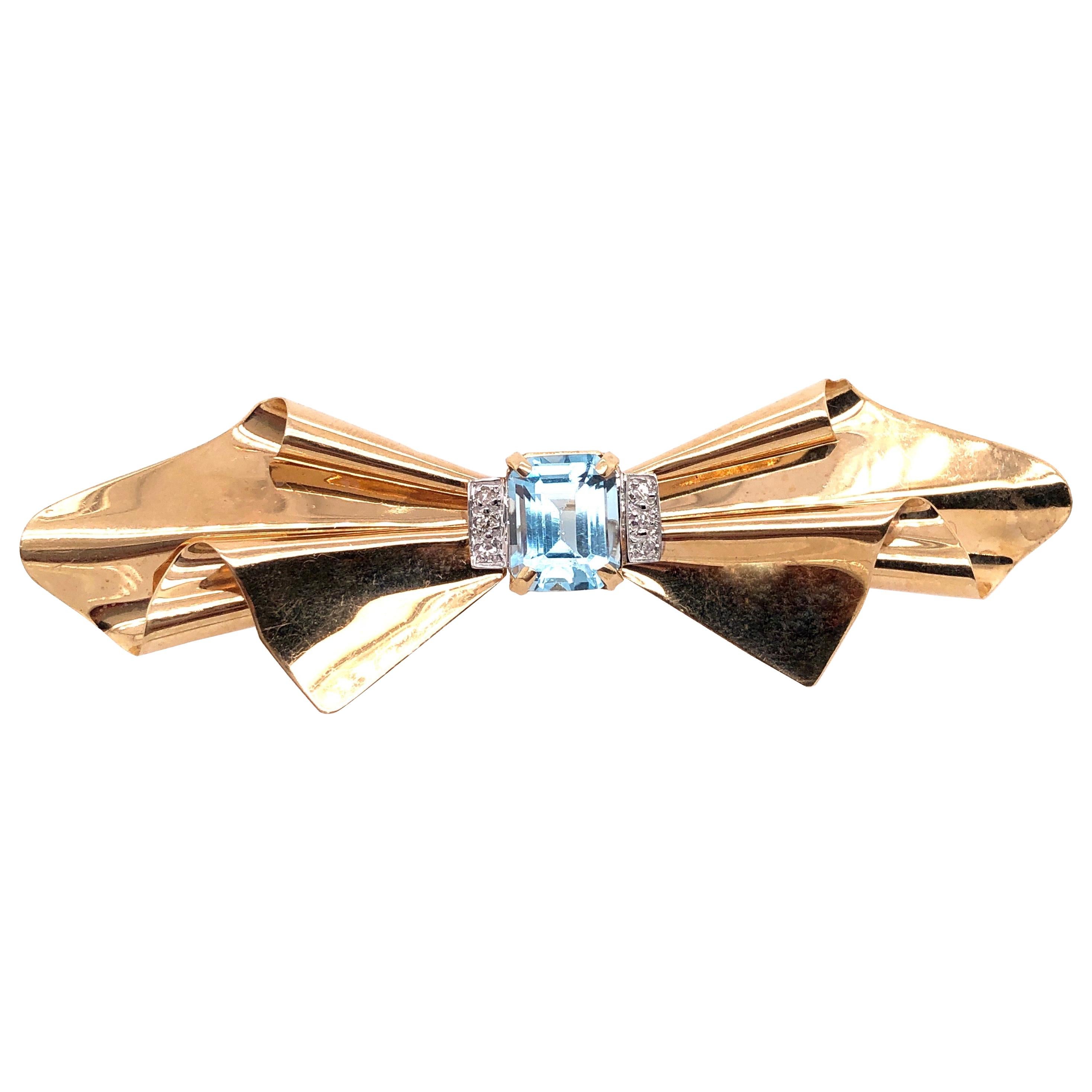 14 Karat Yellow Gold Bow Brooch with Blue Topaz and Diamond Accents For Sale