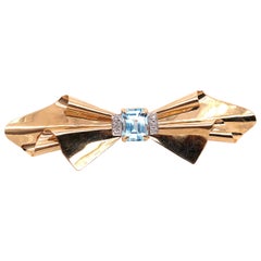 14 Karat Yellow Gold Bow Brooch with Blue Topaz and Diamond Accents
