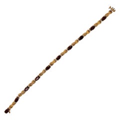 14 Karat Yellow Gold Braided Link Bracelet with Garnets and Diamond Accents