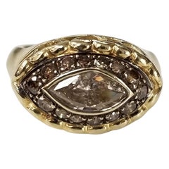 14 Karat Yellow Gold Brown Diamond Halo Ring Containing 1 Marquise Cut Diamond