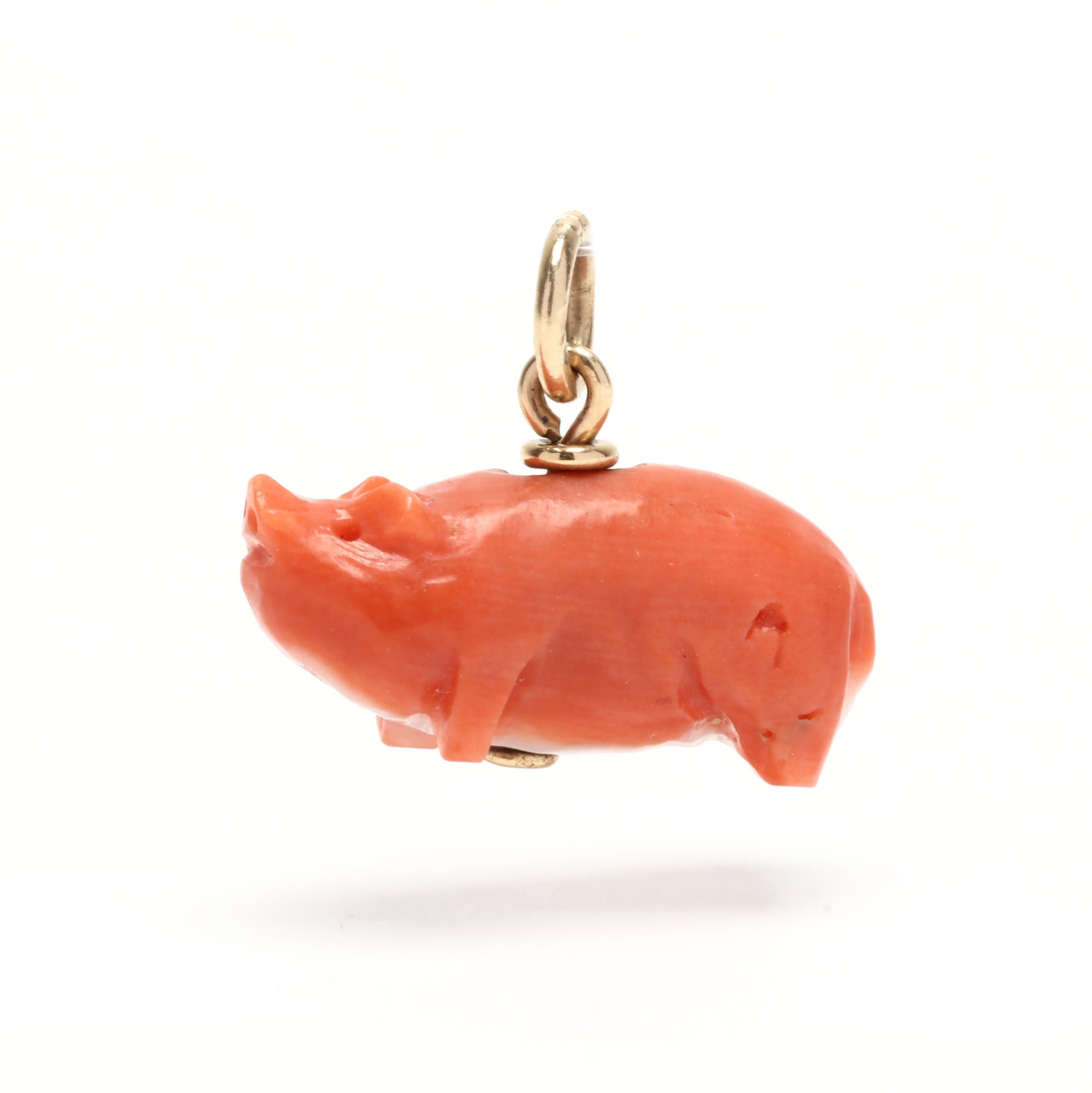 An antique 14 karat yellow gold carved coral pig charm. This Victorian charm features a solid piece of coral carved to depict a pig and with a thin bail.



Length: 11/16 in.



Width: 1/2 in.



Weight: 1.20 dwts.