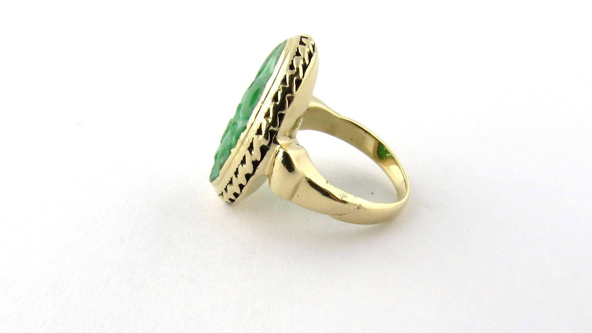 Intricately carved vintage bezel set oval jade ring set in 14K yellow gold. 

Size 3 1/2 16mm x 20mm stone setting. 2mm shank. 

Marked 14K. Weighs 6.4 g, 4.10 dwt. 

Excellent vintage pre-owned condition. Has been professionally polished. 

Item