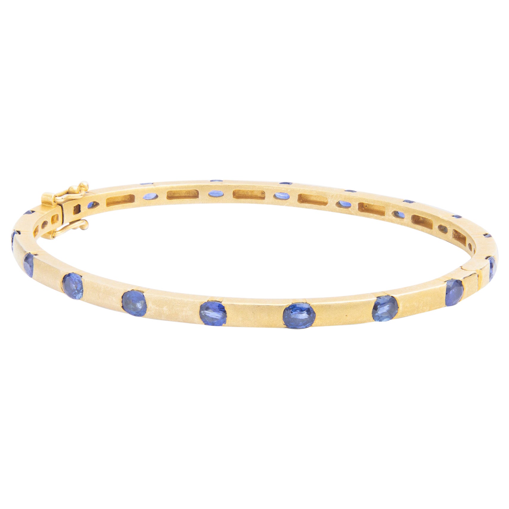 14 Karat Yellow Gold 
Ceylon Sapphire Hinged Bangle