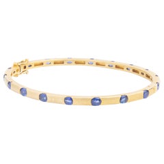 14 Karat Yellow Gold & Ceylon Sapphire Hinged Bangle