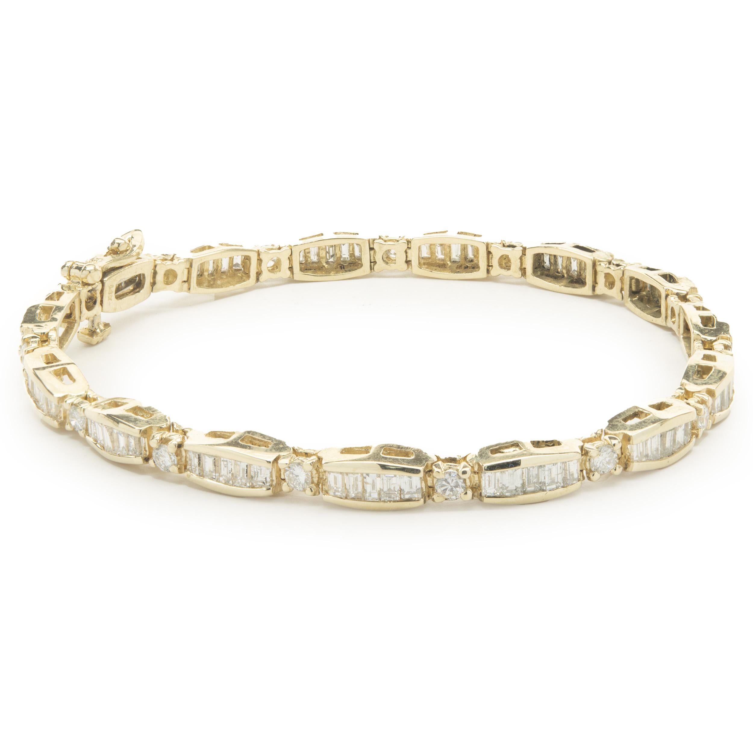 Designer: custom design
Material: 14K yellow gold
Diamonds: 75 baguette & 15 round brilliant cut = 2.45cttw
Color: G
Clarity: SI1
Dimensions: bracelet will fit up to a 7-inch wrist
Weight: 13.60 grams