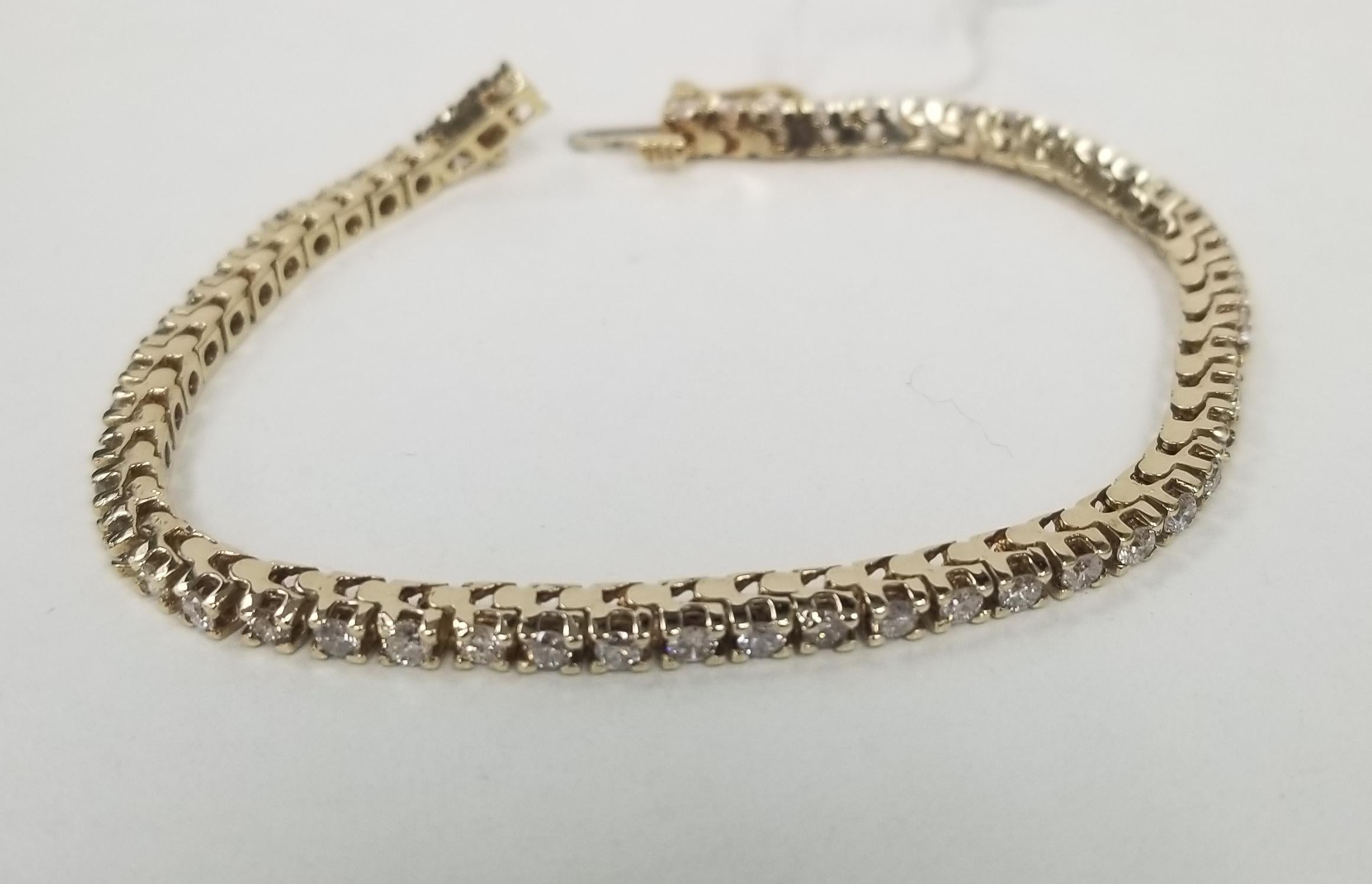 This is very beautiful 14k yellow gold classic box custom diamond tennis bracelet with 53 round diamonds color F-G and clarity VS2 weighing 2.50cts. very fine quality diamonds, bracelet measures 6.5 inches with clasp and safety.
Specifications:
main