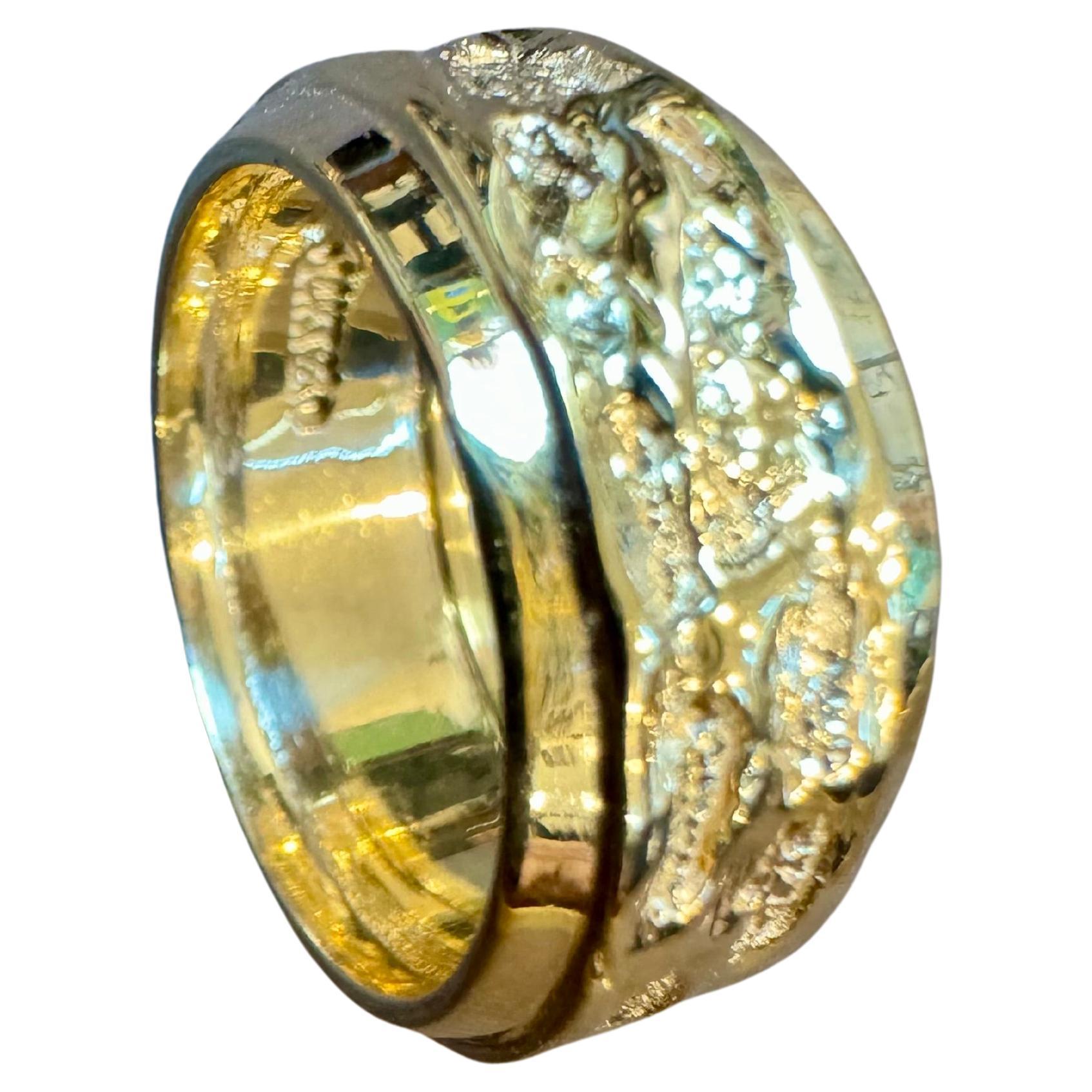 Introducing an 14 Karat Yellow Gold Classic Wide Wedding Band with a unique design, available in a unisex size 4.5. This timeless piece features a light classic net design that elegantly wraps around the entire band, adding a touch of