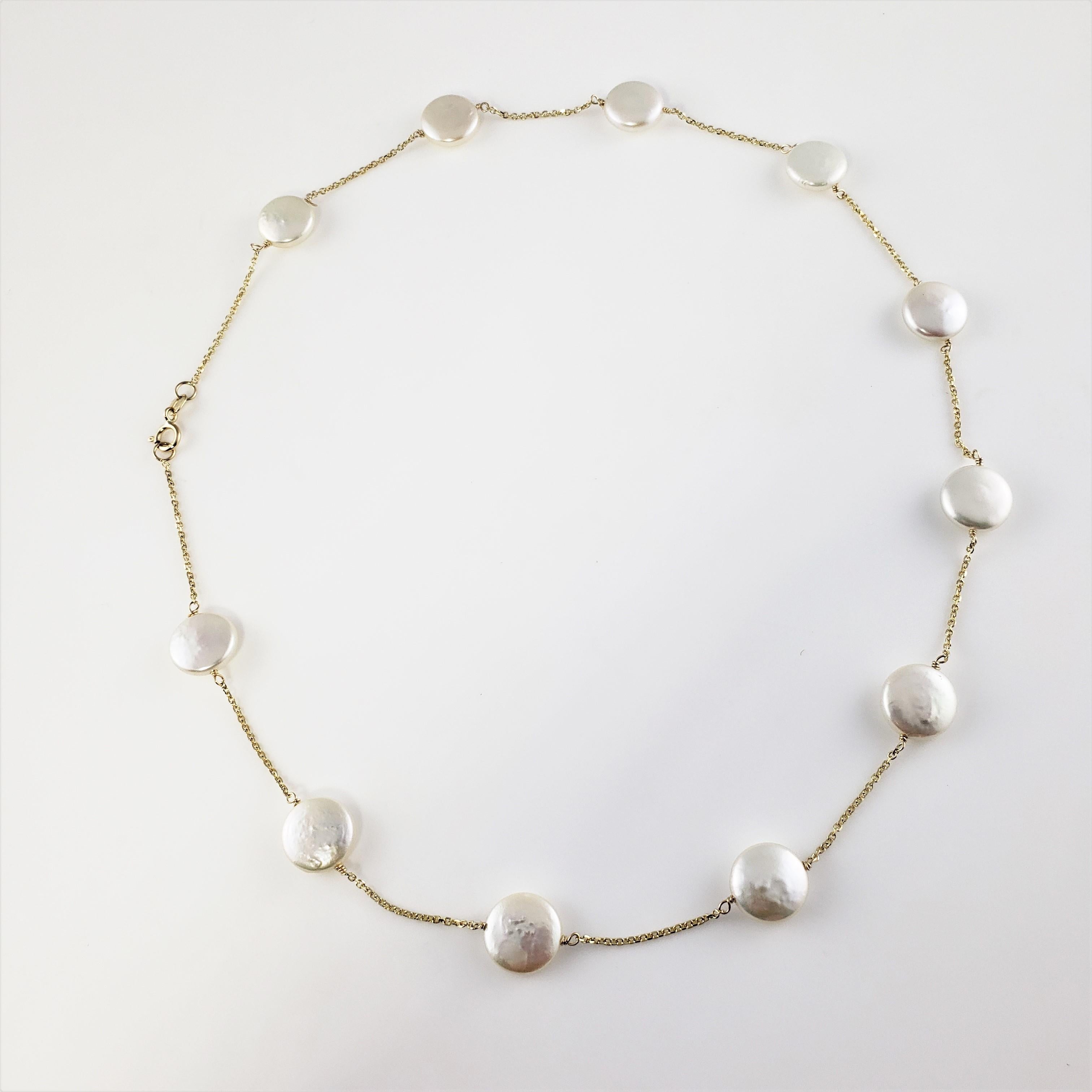 14 Karat Yellow Gold Coin Pearl Necklace-

This lovely necklace features 11 coin pearls (11 mm each) set on a classic 14K yellow gold chain.

Size:  17.5 inches 

Weight:  6.3 dwt. /  9.8 gr.

Stamped:  14K

Hallmark:  RCI

Very good condition,