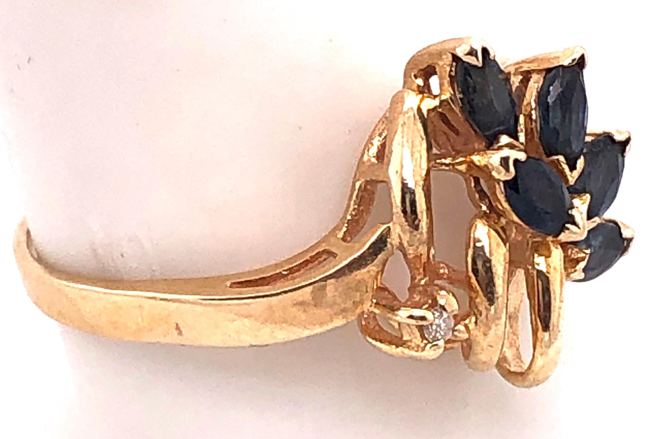 14 Karat Yellow Gold Contemporary Ring with Sapphire and Round Diamonds.
Size 9.5
3 grams total weight.