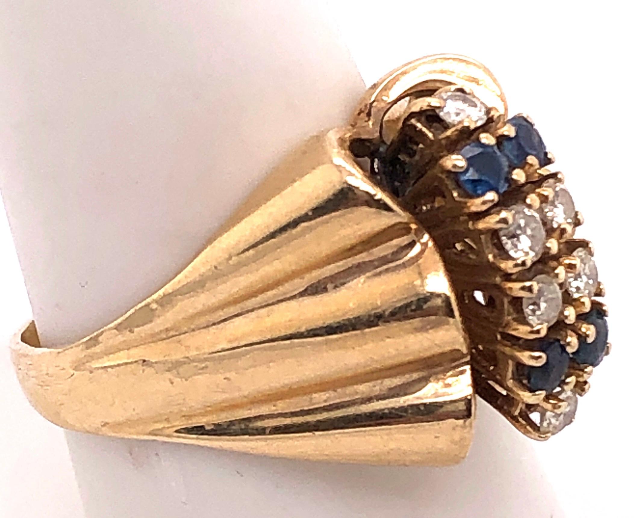 14 Karat Yellow Gold Contemporary Ring with Sapphire and Diamonds.
Size 8
7.6 grams total weight.