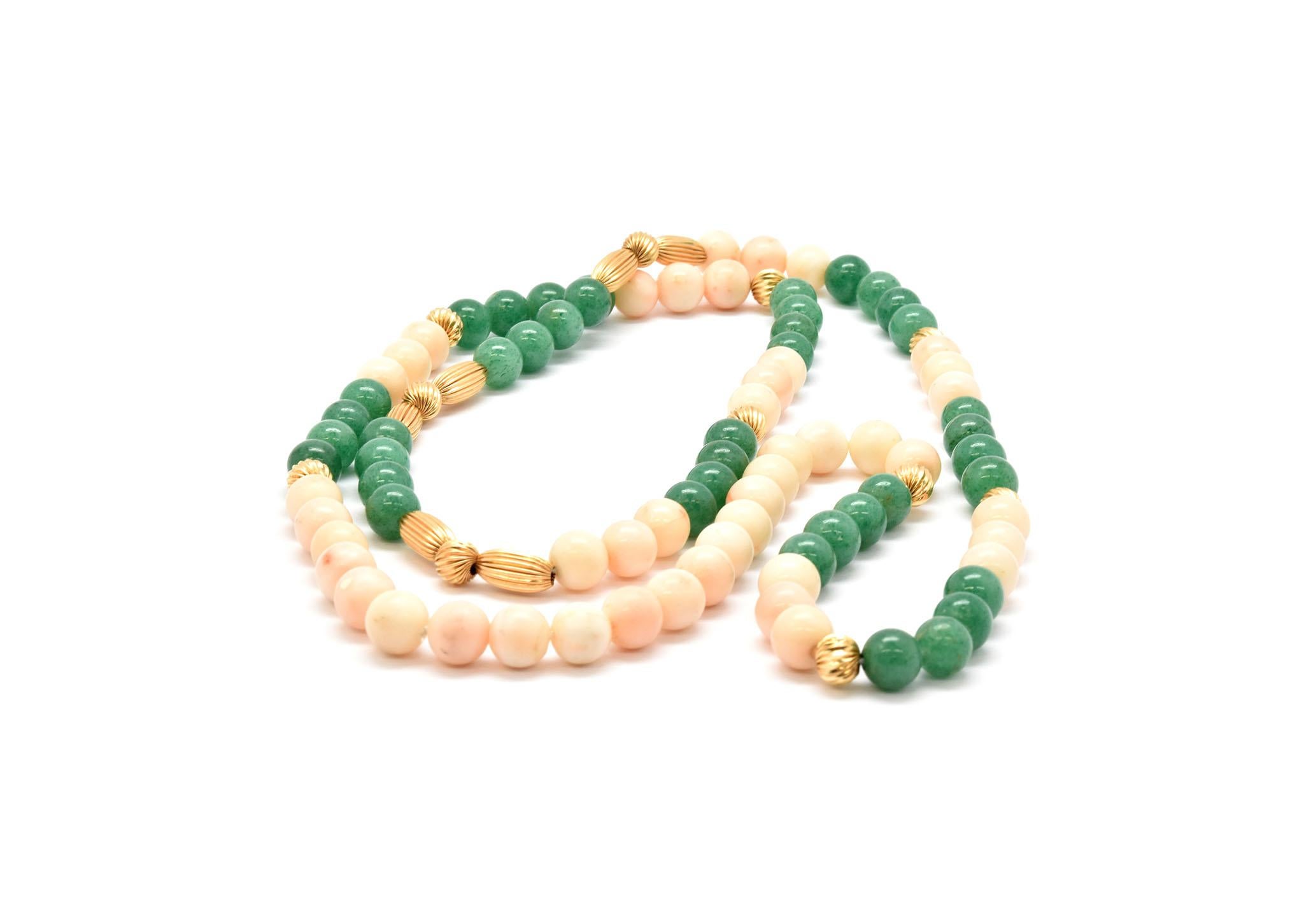 This strand of beads features both pink coral and green jade with 14k yellow gold accent beads. The beads measure about 9mm in diameter, and the necklace measures 34 inches in length.
