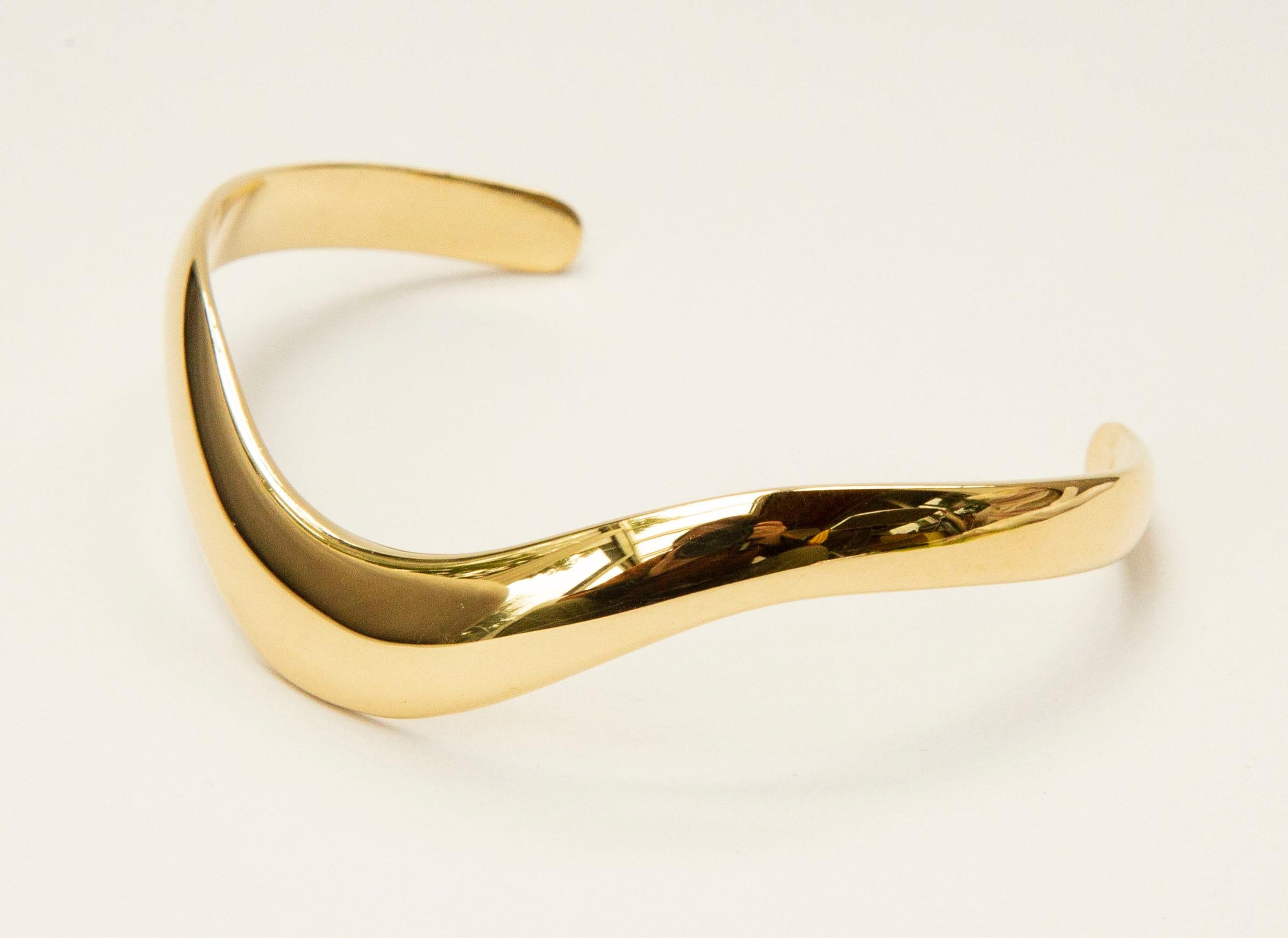 A cuff bracelet made of  14 karat solid yellow gold. The bracelet features a modern, minimalist  Scandinavian design. It is very suitable to be worn every day as well as during special occasions. 
The width of the bracelet varies from 10.5 mm in the