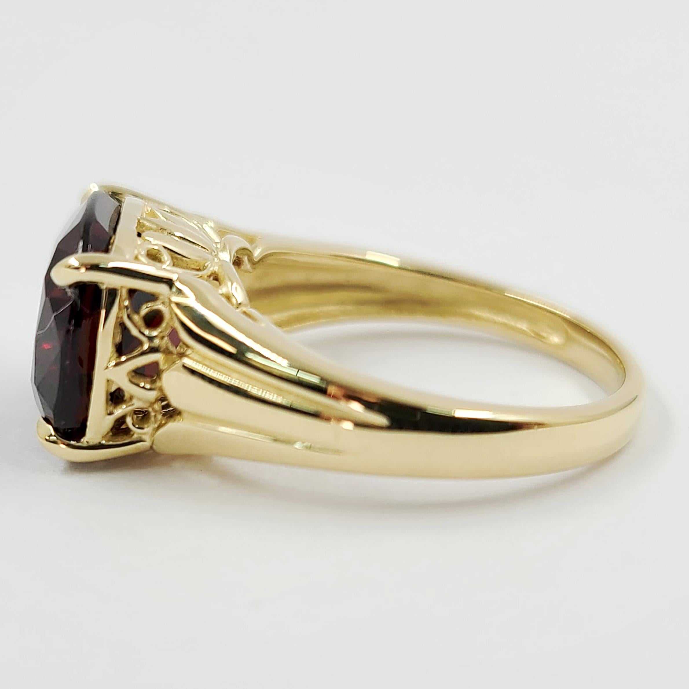 NEW 14 Karat Yellow Gold Cocktail Ring Featuring A 7.06 Carat Cushion Cut Garnet. Finished Weight is 5.3 Grams. Current Finger Size 7.25; Purchase Includes One Sizing.