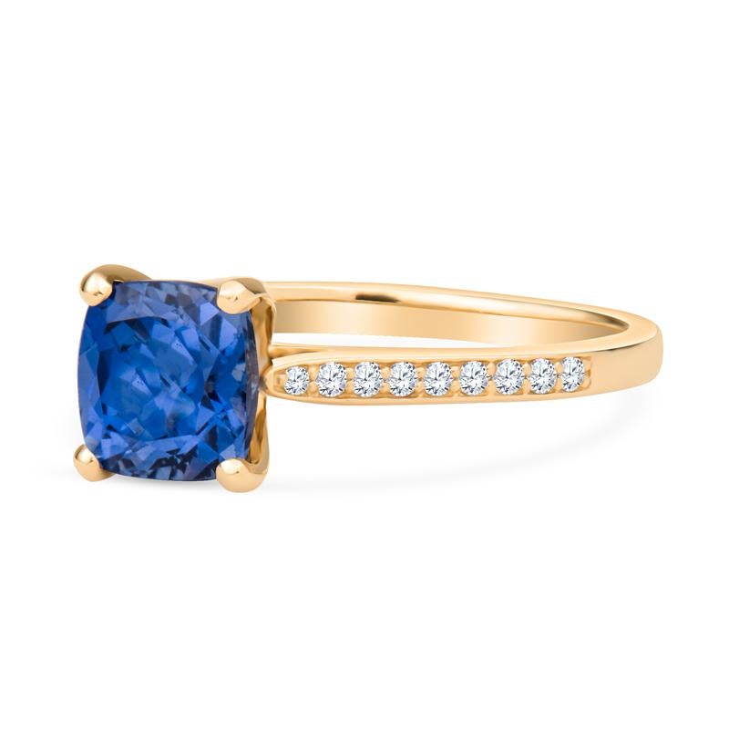 This fashion ring features a cushion cut tanzanite accented by 0.13 carat total weight in round diamonds on the shank. It is set in 14 karat yellow gold. The ring is a size 7.25 but can be resized upon request. 
Measurements: Tanzanite measures