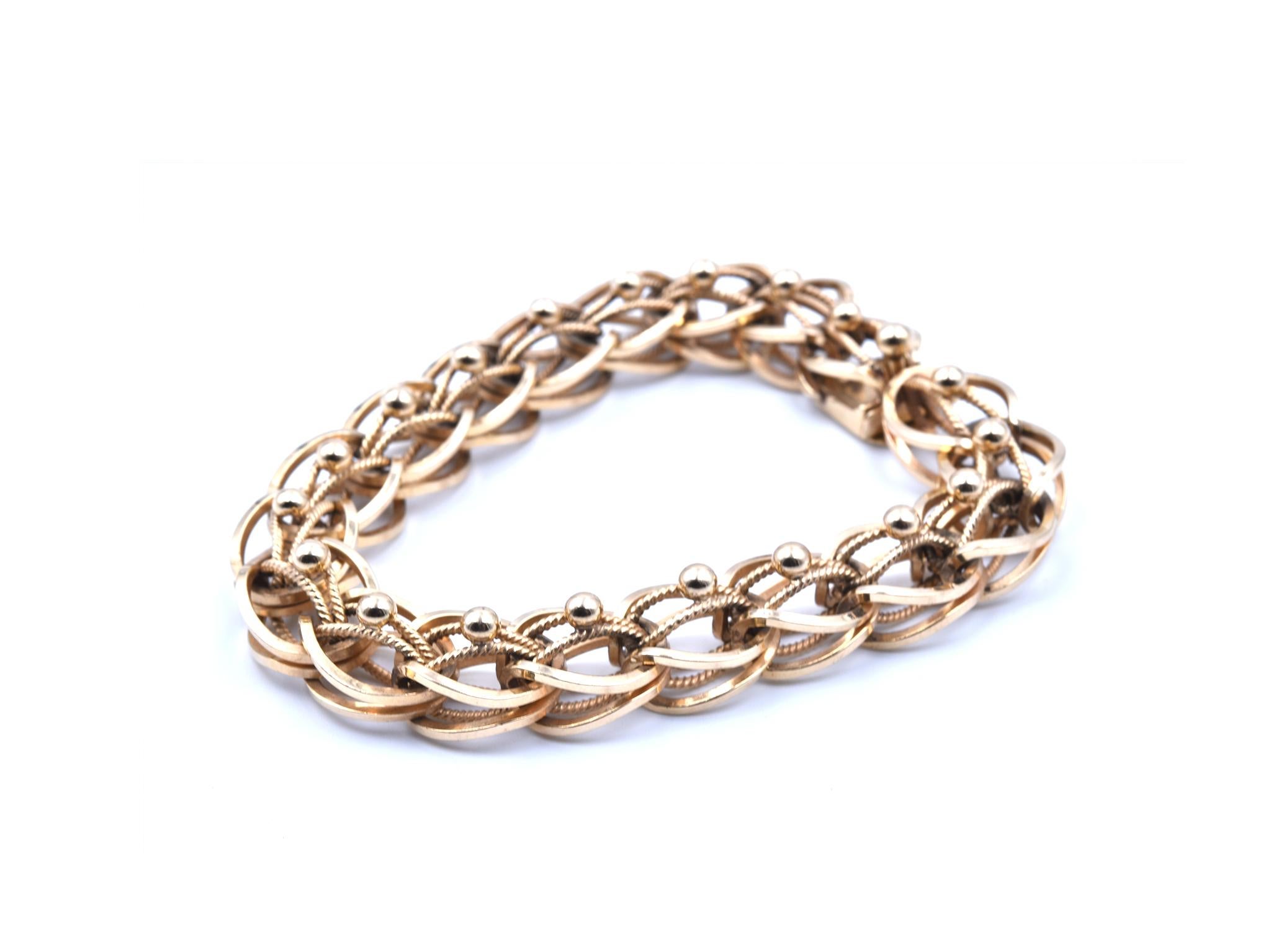 Designer: custom design
Material: 14k yellow gold
Dimensions: bracelet is 8 -inch long and 11.97mm wide 
Weight: 41.95 grams
