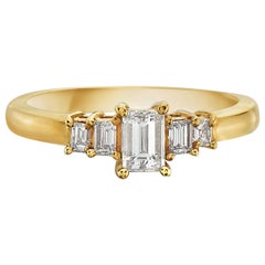 Anillo de compromiso de oro amarillo de 14 quilates con 5 delicadas piedras talla esmeralda