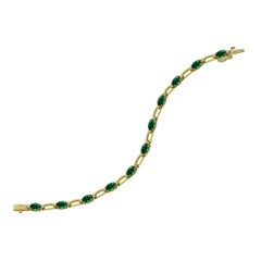 14 Karat Yellow Gold Diamond and Emerald Tennis Bracelet