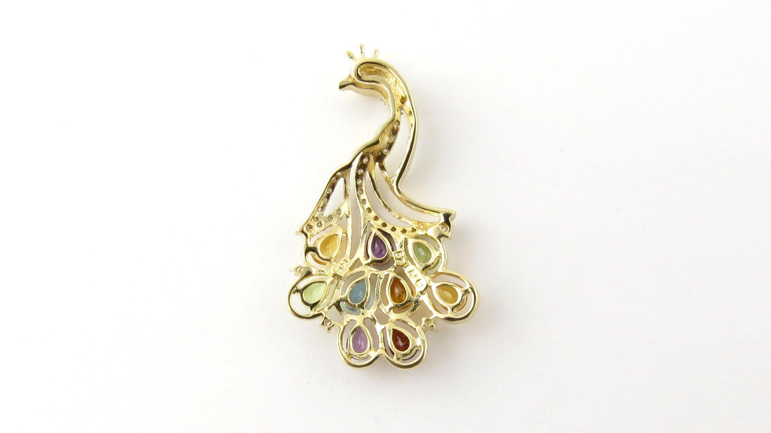 Vintage 14 Karat Yellow Gold Diamond and Gemstones Peacock Pendant. This stunning pendant features a glorious peacock detailed with 37 round single cut diamonds and nine pear-shaped genuine gemstones: two peridots, two amethysts, three citrines, one