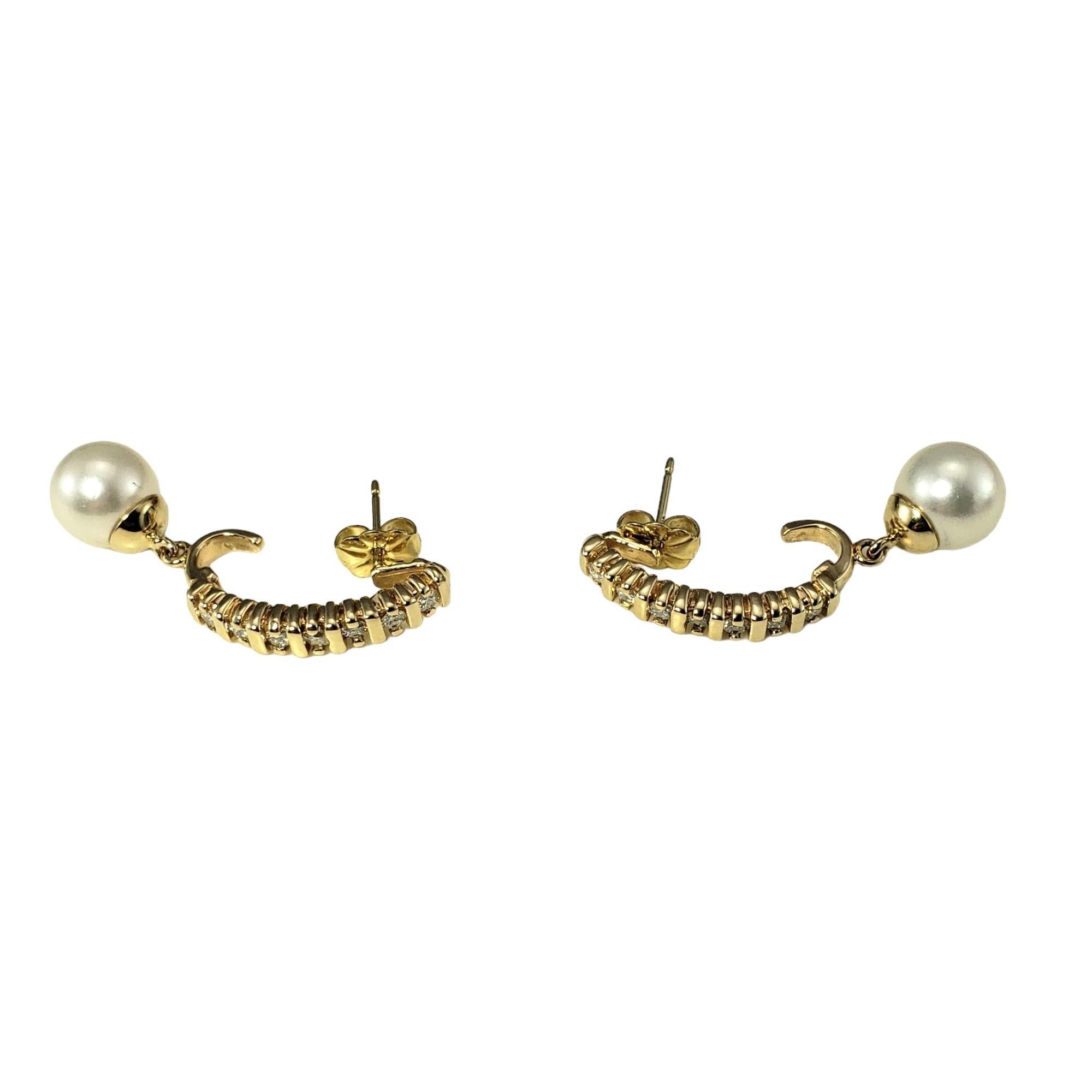 14K Yellow Gold Diamond and Pearl Earrings-

These elegant earrings each feature one round cultured pearl (8 mm) and seven round brilliant cut diamonds set in classic 14K yellow gold.  Push back closures.

Approximate total diamond weight: .42