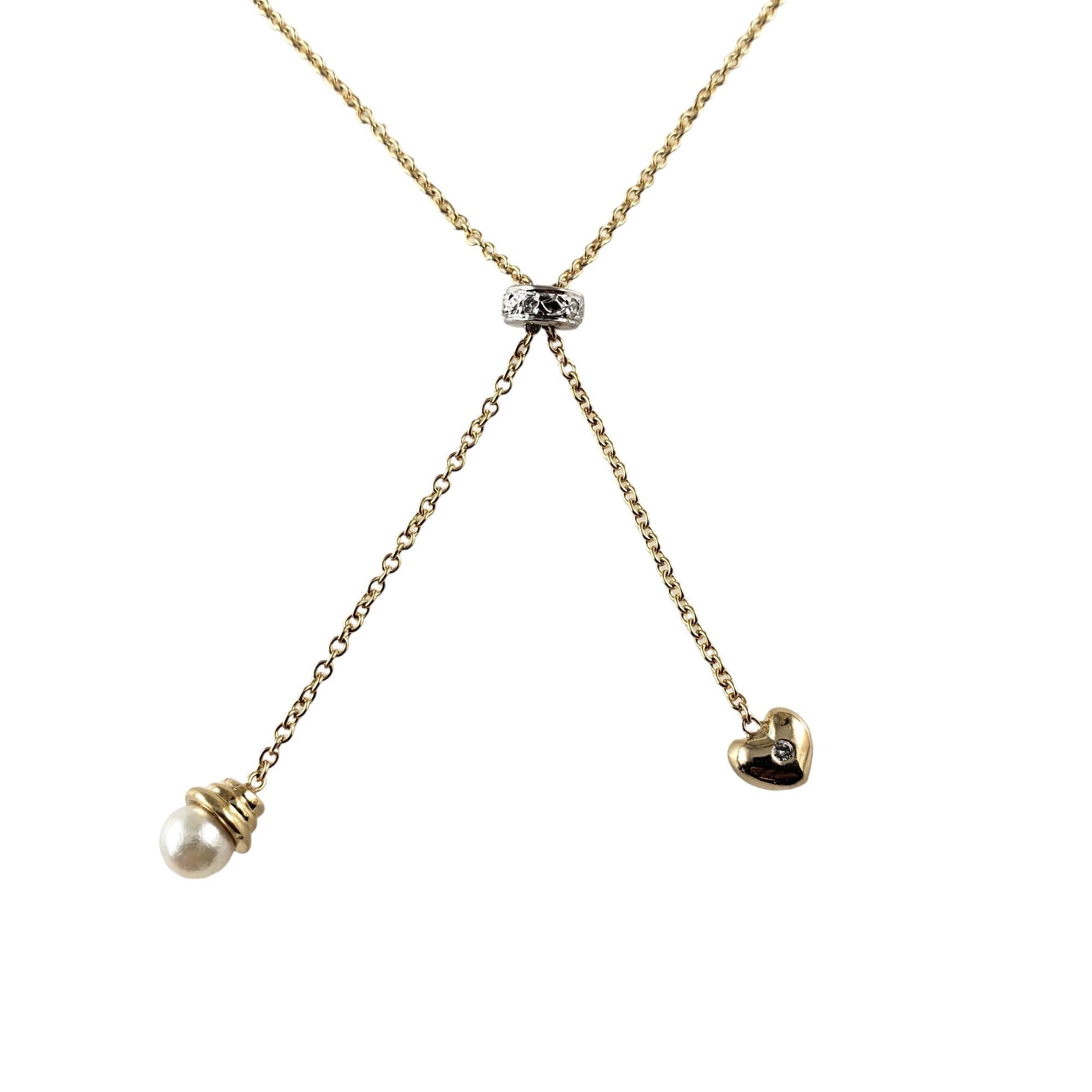Vintage 14 Karat Yellow Gold, Diamond and Pearl Necklace-

This stunning fixed lariat style necklace features seven round brilliant cut diamonds with dangling pearl and heart crafted in beautifully detailed 14K yellow gold.  

Approximate total