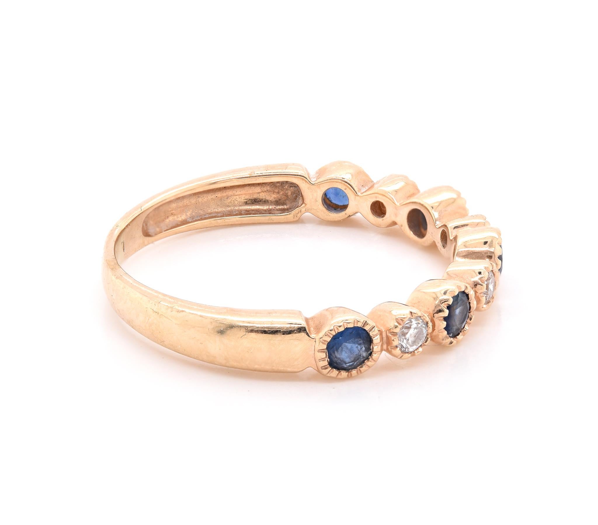 Designer: custom design
Material: 14K yellow gold
Diamonds: 4 round cut = .11cttw
Color: G
Clarity: VS1
Sapphire: 5 round cut = .45cttw
Dimensions: ring top measures 3.12mm wide
Ring Size: 5.75 (please allow two extra shipping days for sizing