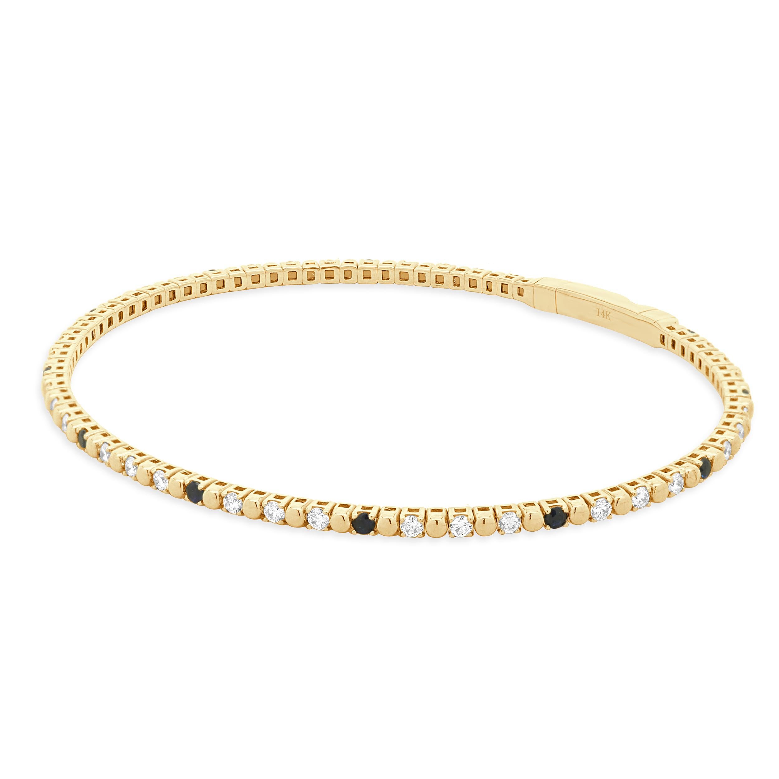 Designer: custom design
Material: 14K yellow gold
Diamond: round brilliant cut = 0.33cttw
Color: G
Clarity: SI1
Sapphires: round cut = 0.29cttw
Dimensions: bracelet will fit up to a 6.5-inch wrist
Weight: 5.31 grams
