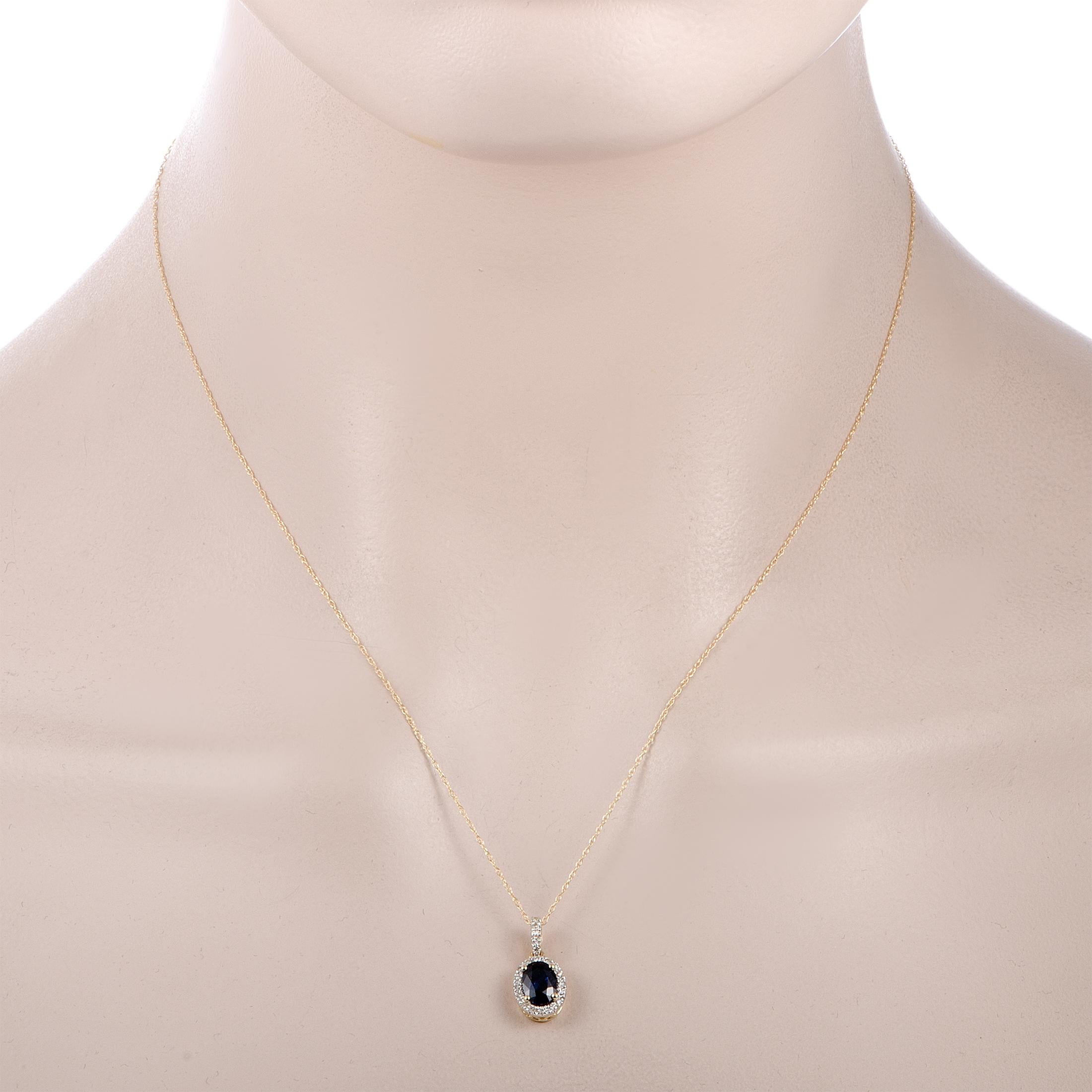 This necklace is made of 14K yellow gold, boasting an 18.00” chain with spring ring closure and a pendant that measures 0.50” in length and 0.31” in width. The necklace weighs 1.7 grams and is set with a sapphire and a total of 0.12 carats of