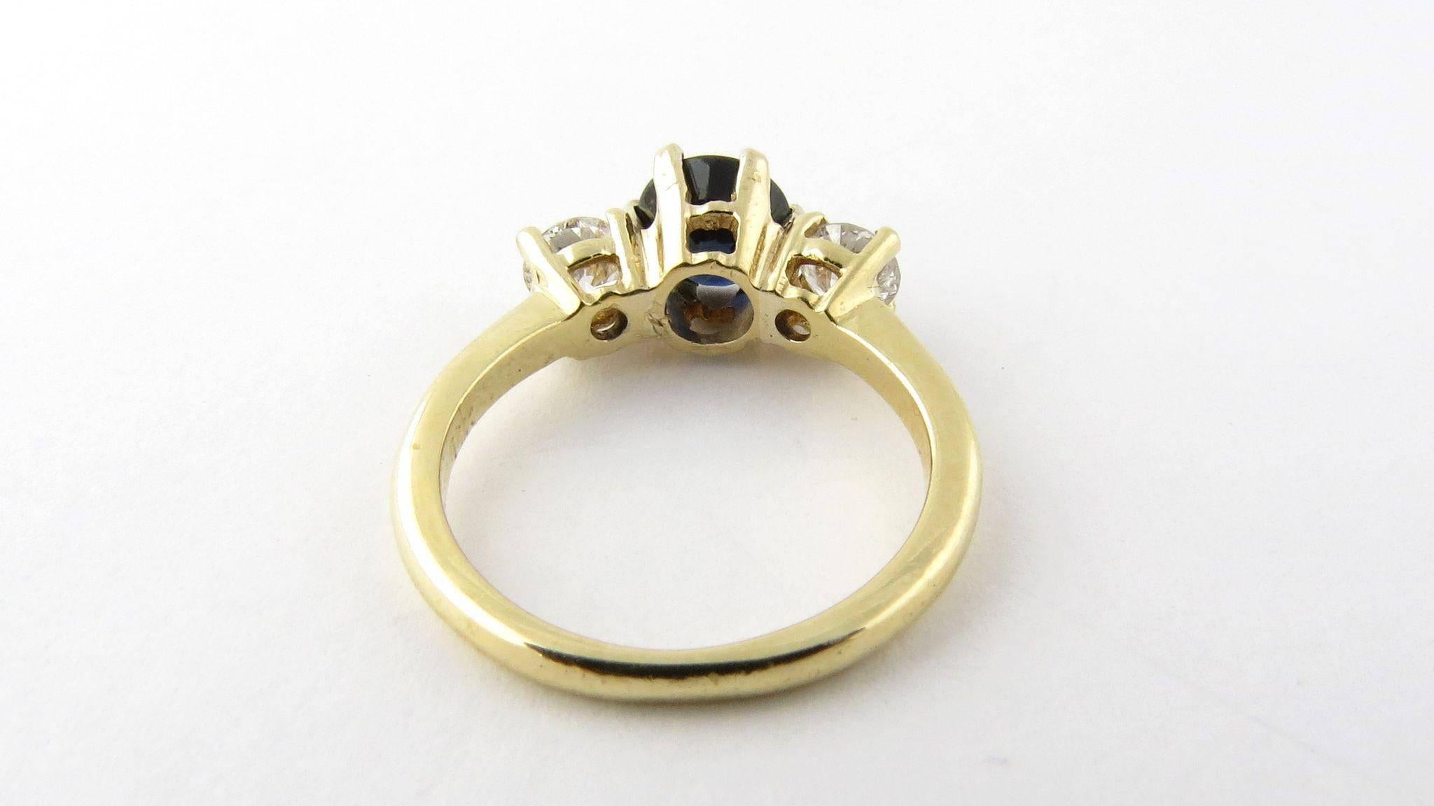 Vintage 14K Yellow Gold Diamond and Sapphire Ring Size 4.75 

This gorgeous sapphire and diamond ring is set with two round brilliant diamonds and one larger deep blue genuine sapphire. 

Round brilliant diamonds are approximately .25 carats each