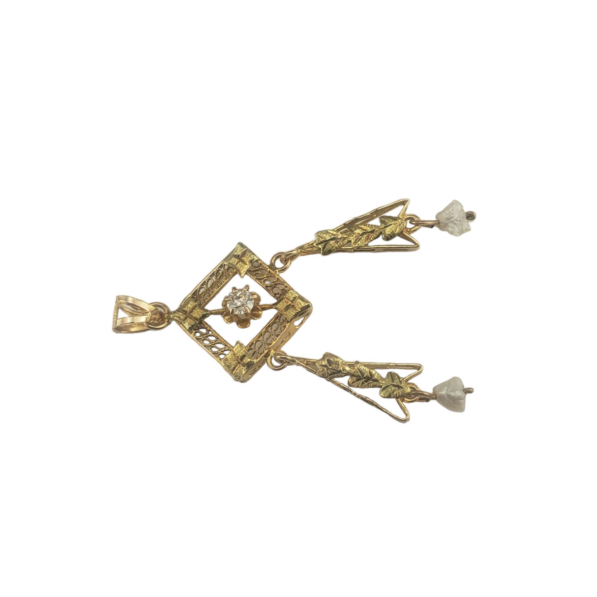 Vintage 14 Karat Yellow Gold and Diamond Pendant-

This elegant pendant features one European cut diamond and two freshwater pearls set in beautifully detailed 14K yellow gold.

Approximate total diamond weight: .07 ct.

Diamond color: G

Diamond