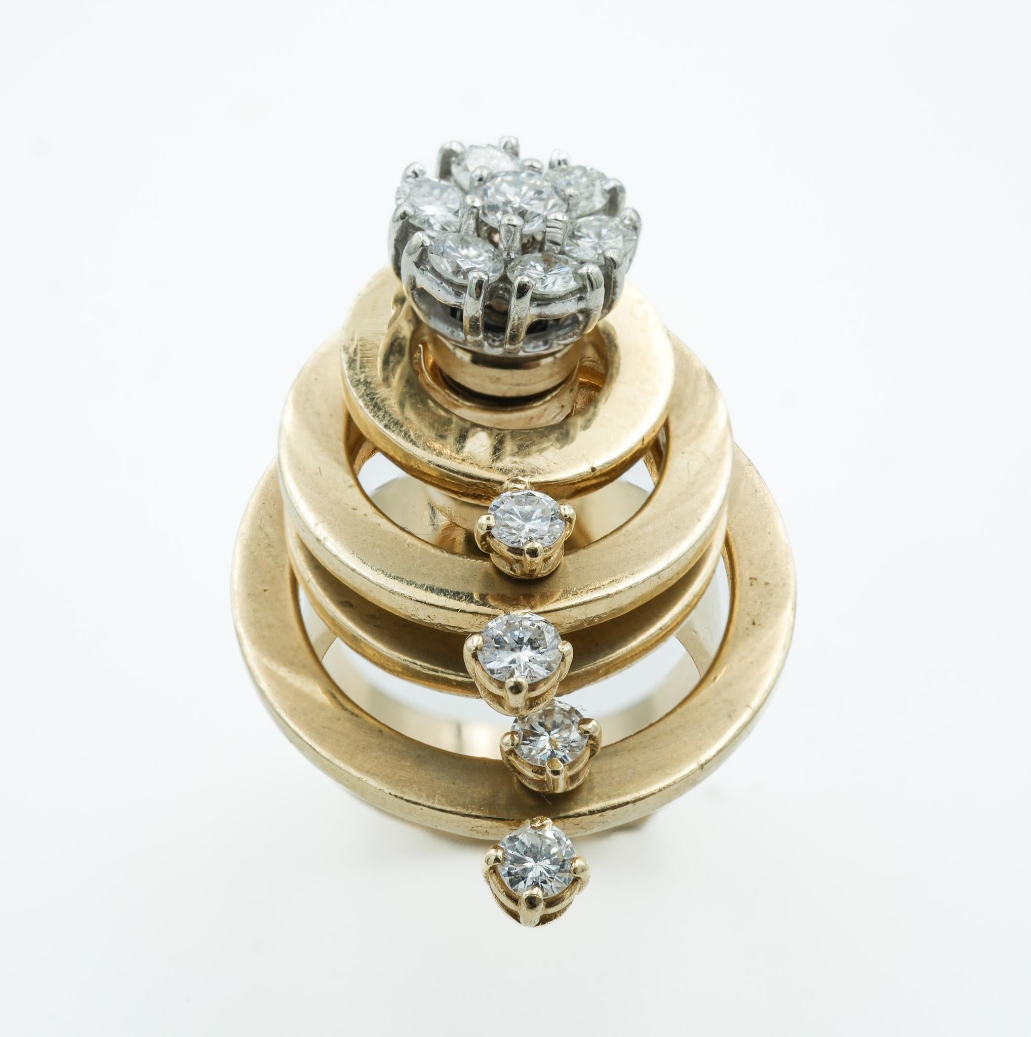 Presenting an opulent example of 1980s jewelry artistry. This articulated spinner ring, crafted from bright 14 karat yellow gold, features a dynamic array of four spinning bands each orbiting a sumptuous diamond cluster that serves as the