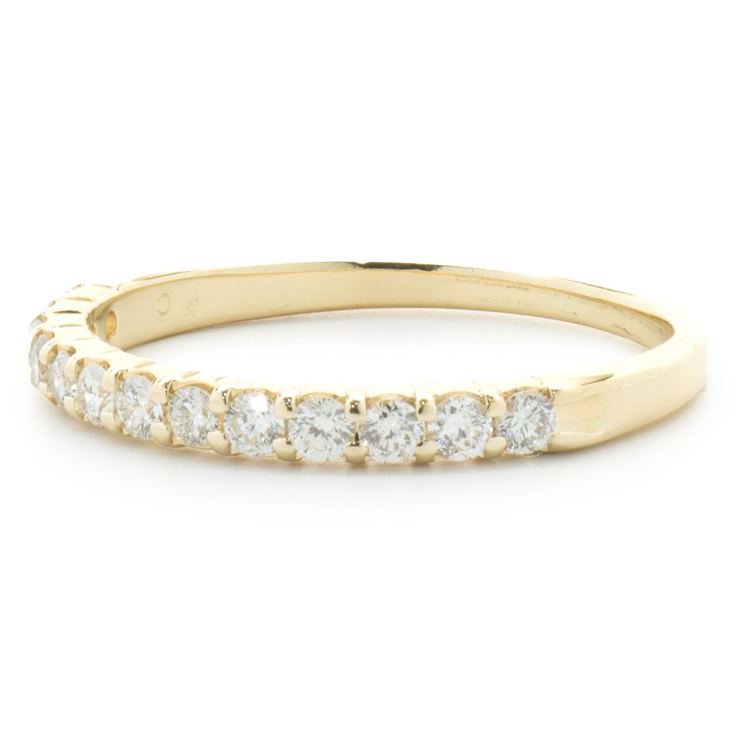 Designer: custom
Material: 14K yellow gold
Diamonds: 13 round brilliant cut = 0.26cttw
Color: H
Clarity: SI1
Size: 5 (please allow two additional shipping days for sizing requests)  
Dimensions: ring measures 2mm in width
Weight: 1.27 grams
