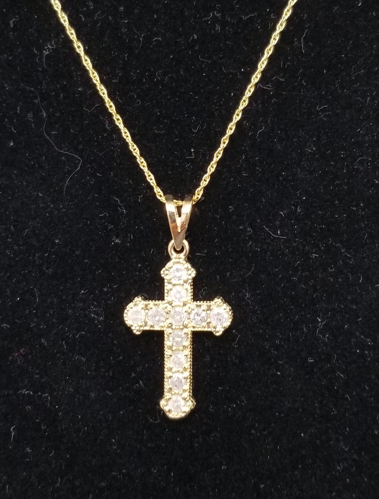 14k yellow gold diamond cross containing 11 round full cut diamonds fair quality weighing .78pts. on a 16 inch link chain.