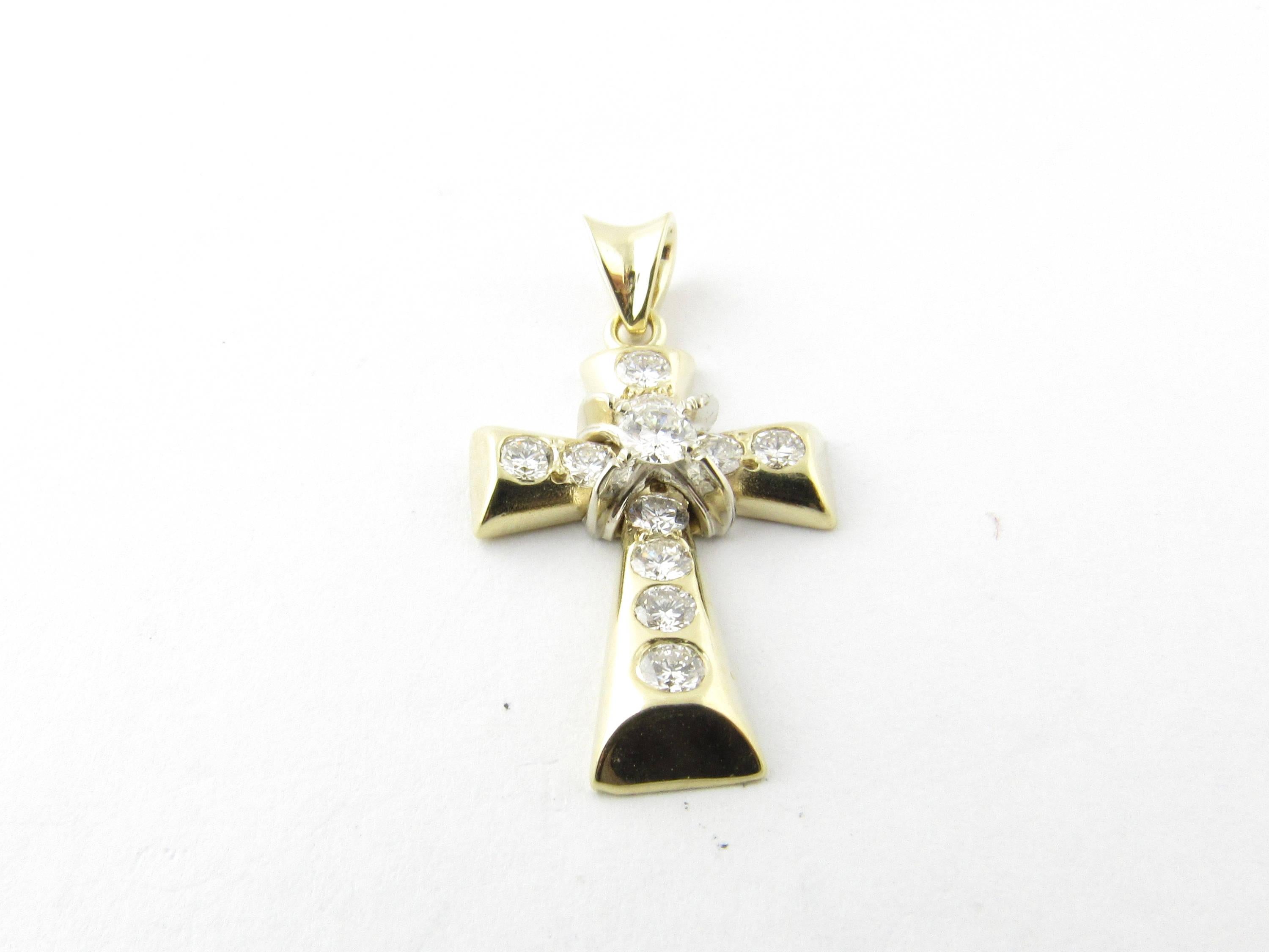 Vintage 14 Karat Yellow Gold Diamond Cross Pendant

This dazzling pendant features 11 round brilliant cut diamonds set in polished 14K yellow gold.

Approximate total diamond weight: 1.03 cts. (center: .15 ct., 4 x .10 ct., 6 x .08 ct.)

Diamond