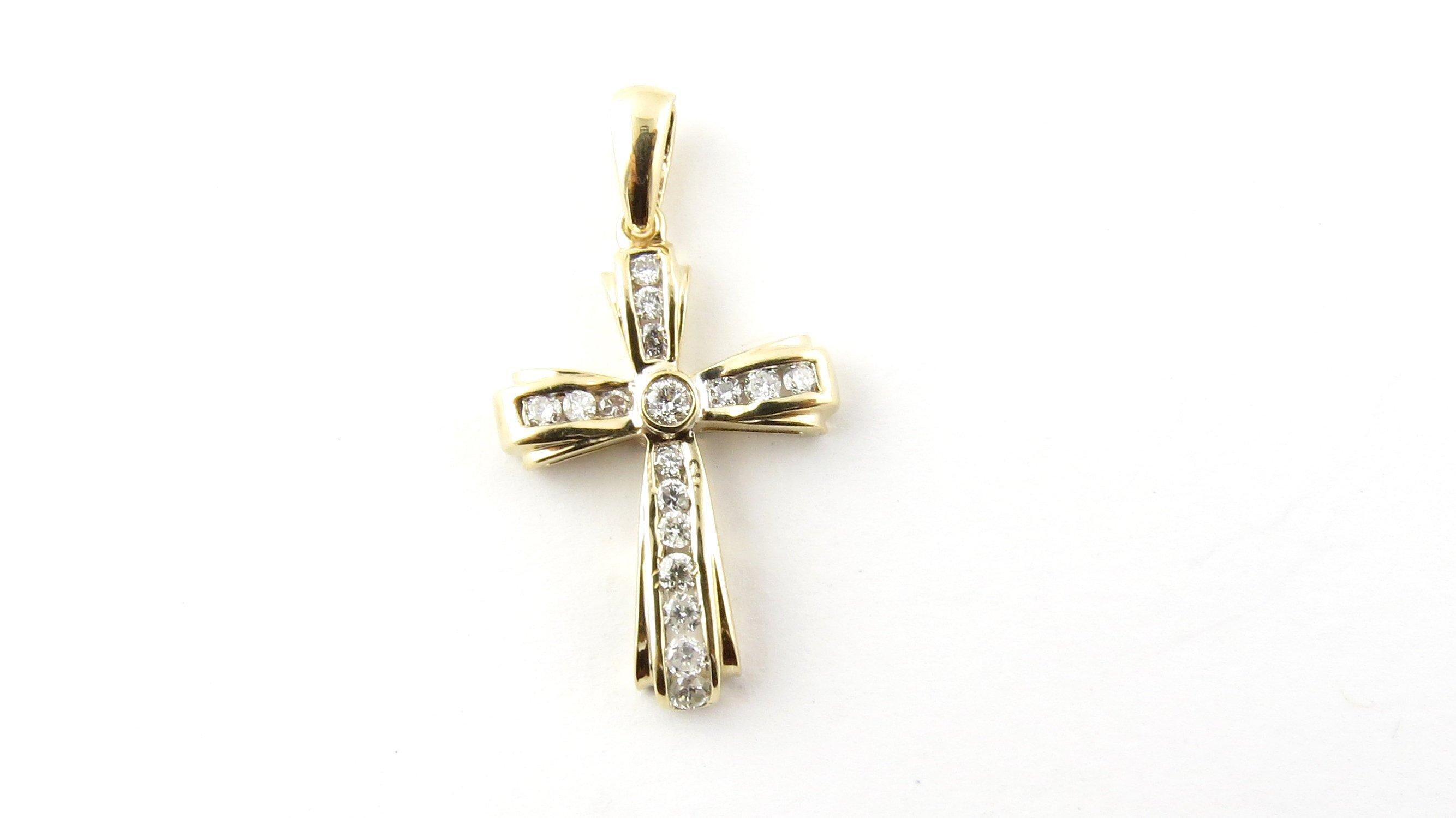 Vintage 14 Karat Yellow Gold Diamond Cross Pendant
This sparkling cross pendant features 17 round brilliant cut diamonds set in meticulously detailed 14K yellow gold. 
Approximate total diamond weight: .50 ct. 
Diamond color: H-K 
Diamond clarity: